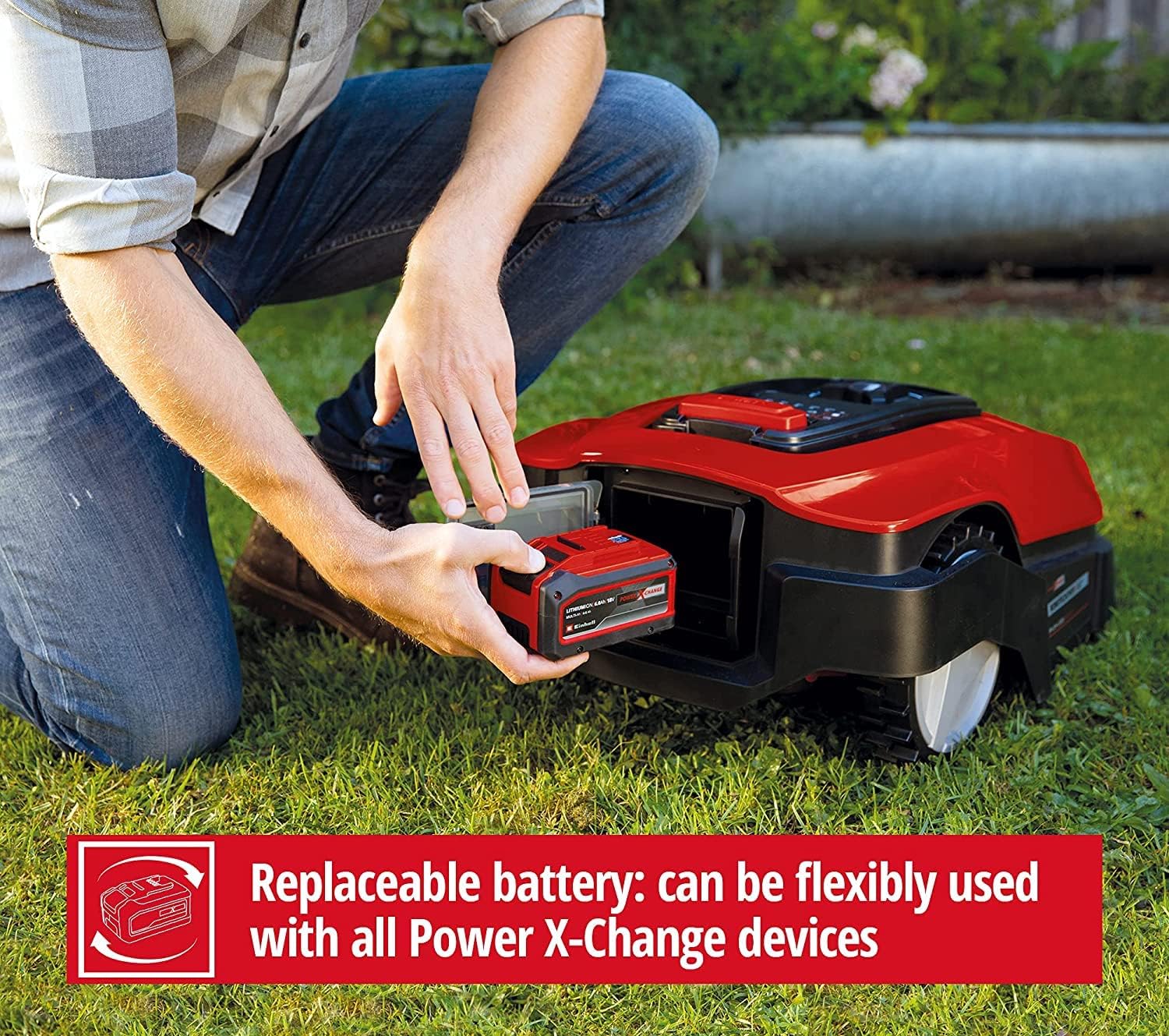 A person inserting a Power X-Change battery into the robotic lawnmower, demonstrating its replaceable nature and compatibility with other devices.