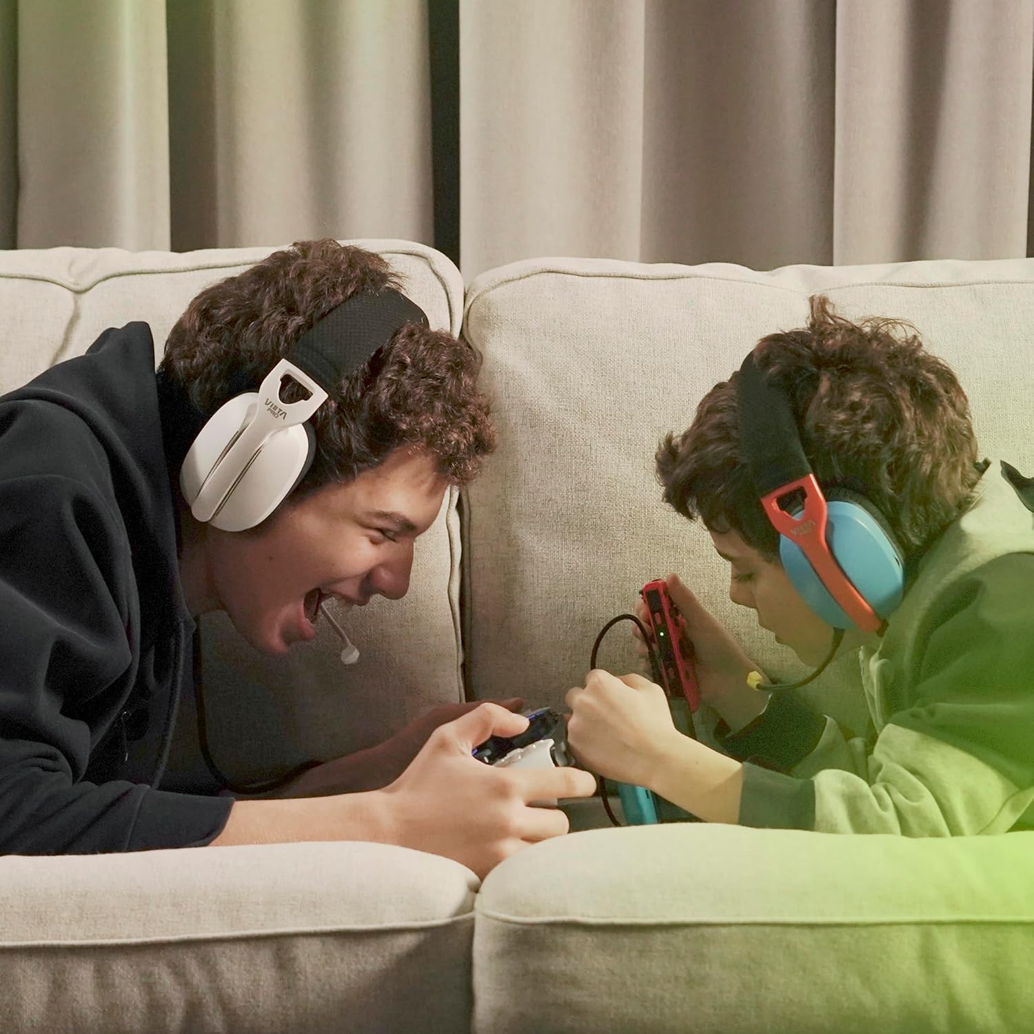 Two young men playing video games with Vieta Pro Aura Gaming Headsets