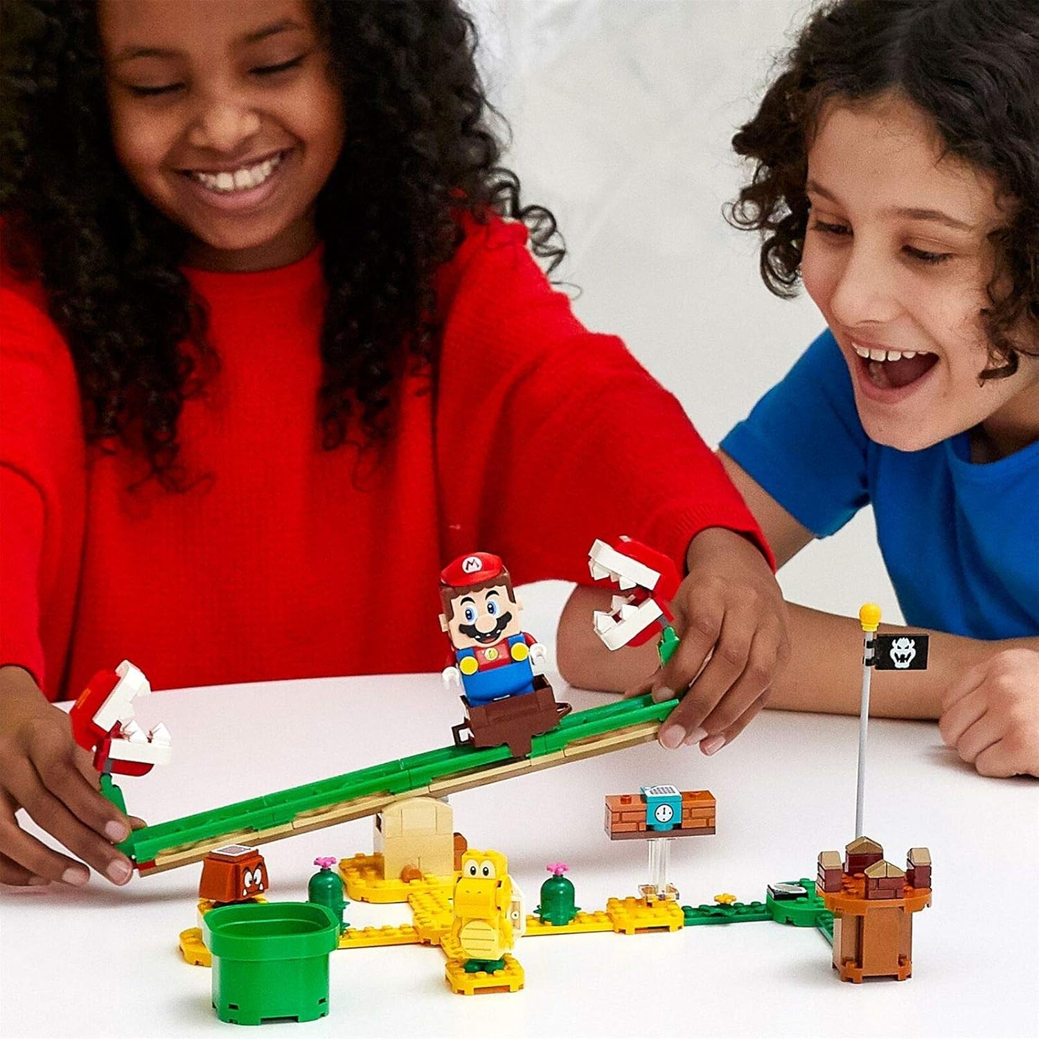 Children playing with a LEGO Super Mario set