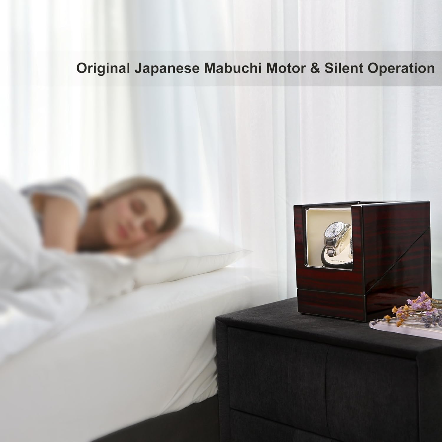 SONGMICS Double Watch Winder UJWW11RD placed on a bedside table, with a person sleeping peacefully in the background, illustrating its quiet operation.