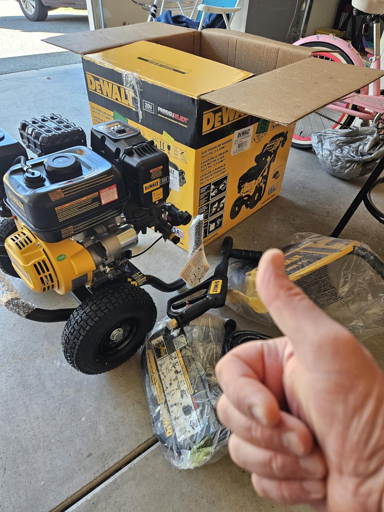 DeWalt DXPW3300-S in use on patio with 3300 PSI label and cleaning power messaging