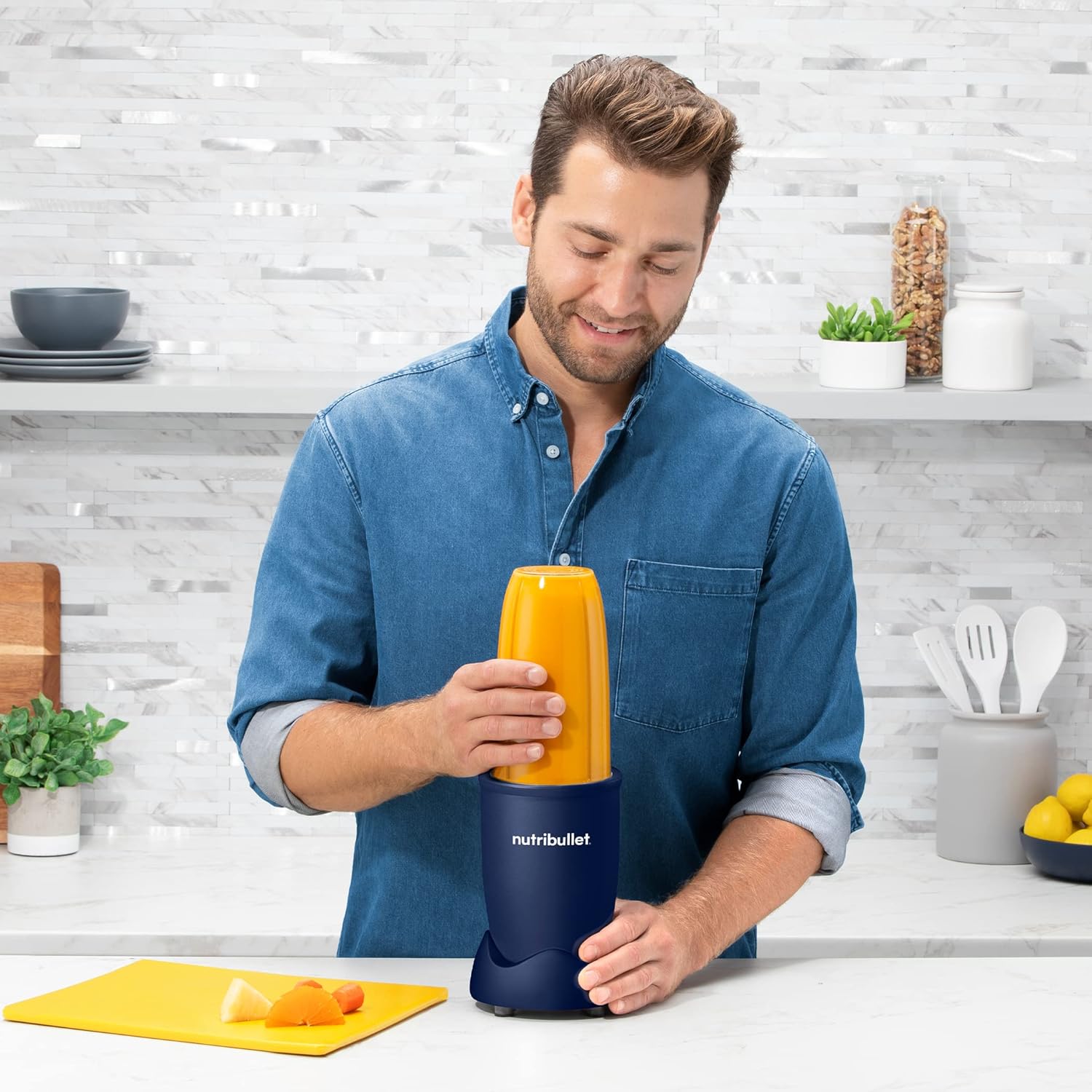 Man preparing ingredients in a NutriBullet cup