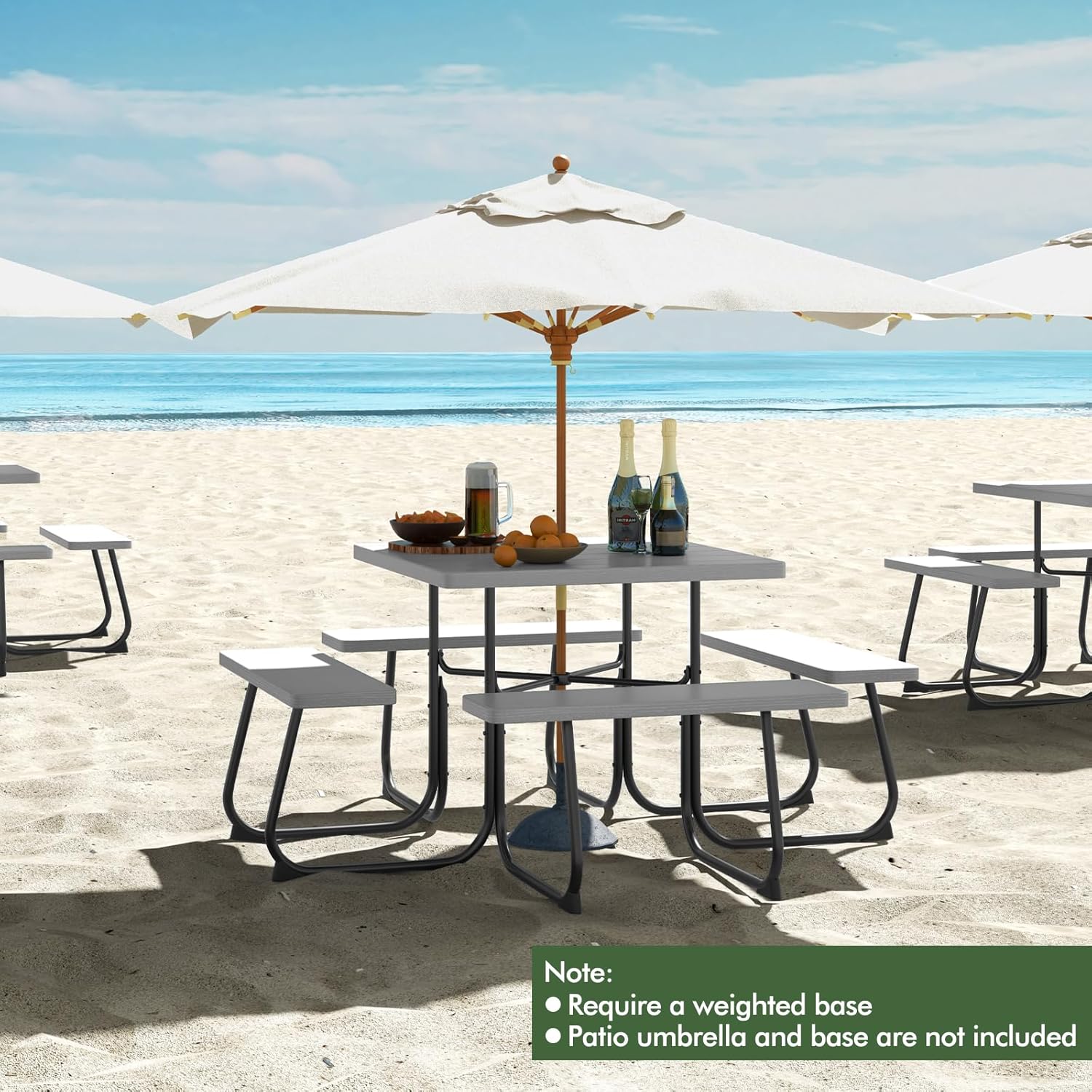 HAPPYGRILL picnic table set with an umbrella on a beach.
