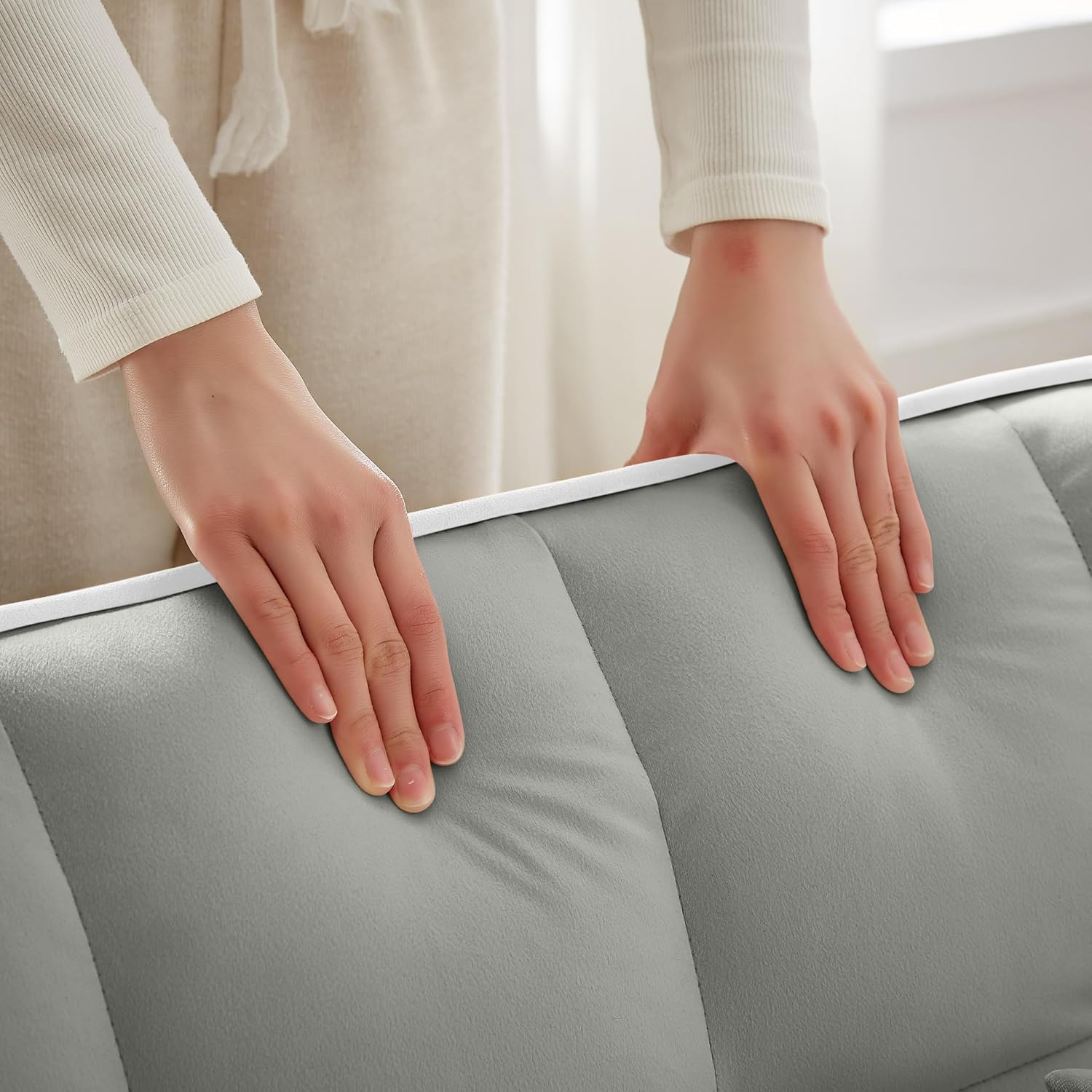 Hand touching the velvet fabric of the chair