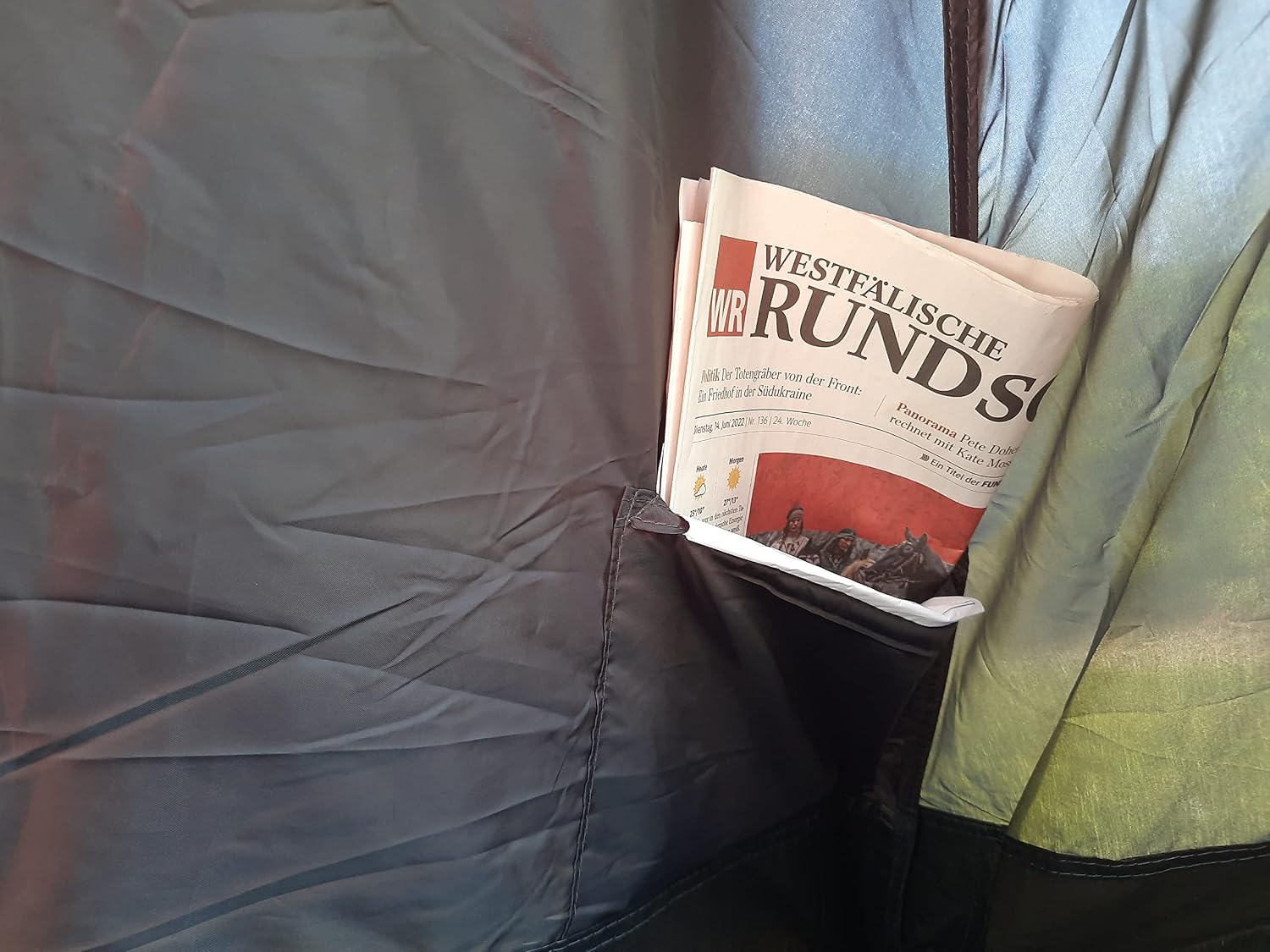 Interior tent pocket holding a newspaper
