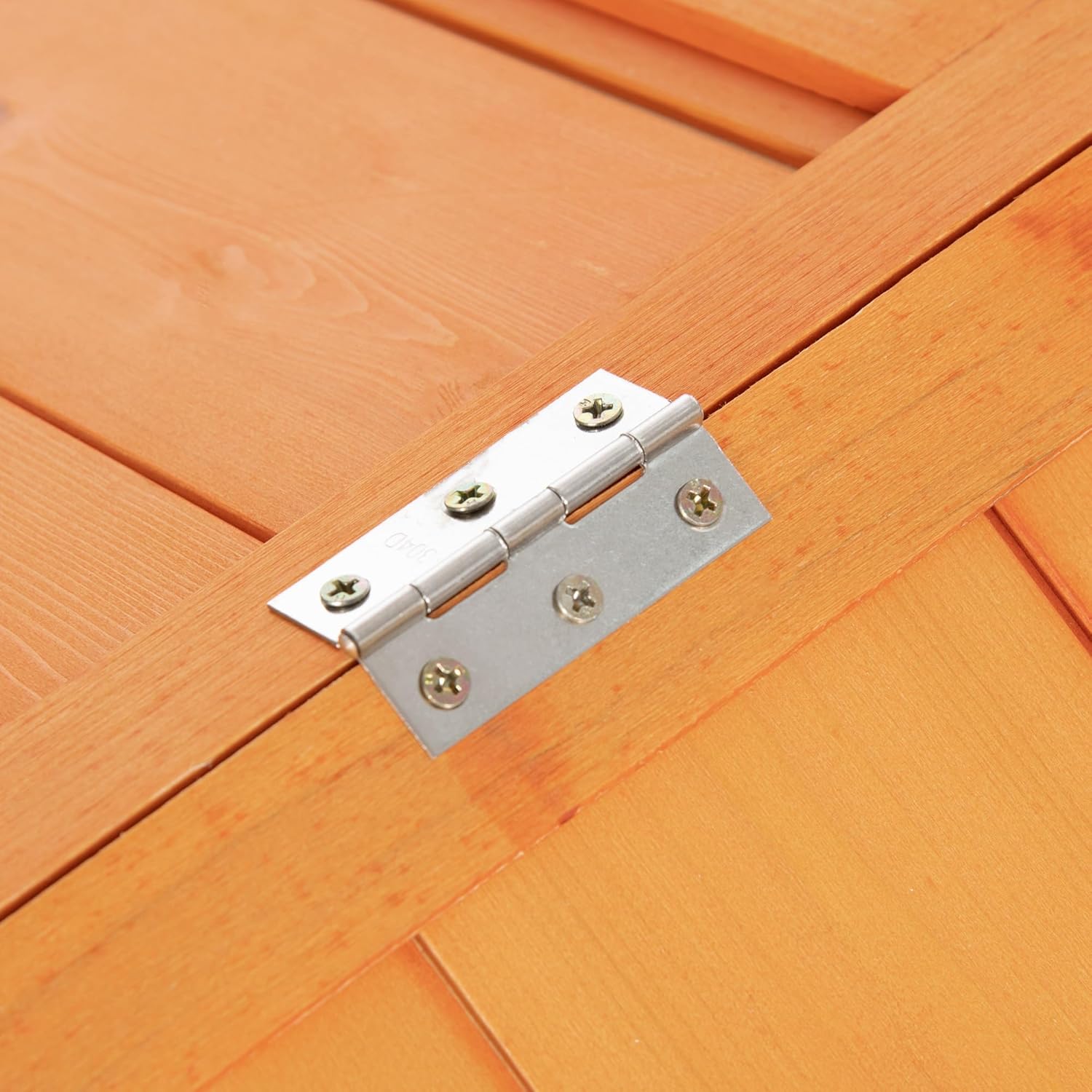 Close-up of a hinge on the chicken coop