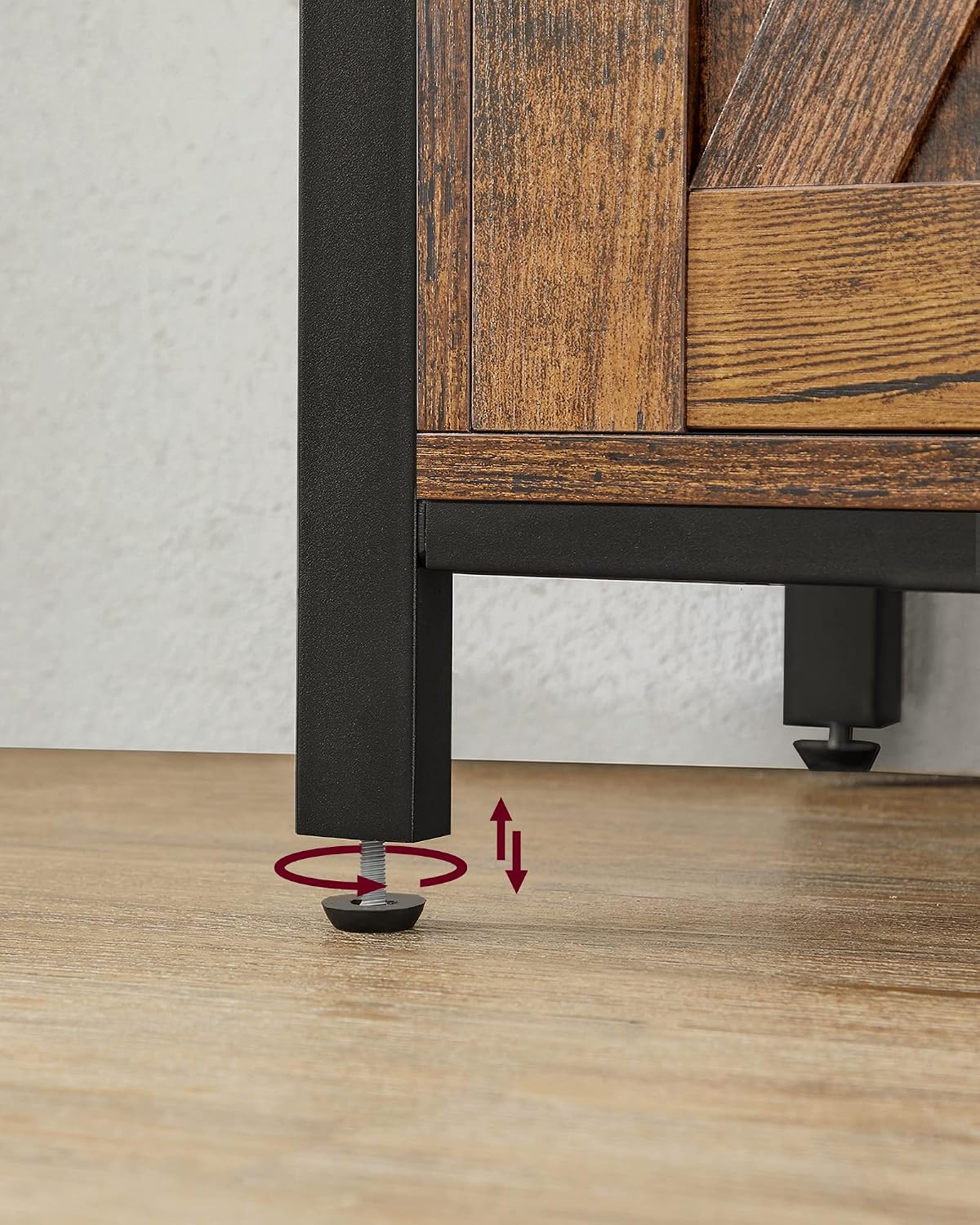 Close-up of an adjustable foot on the VASAGLE LSC092B01 Sideboard, showing how it can be rotated to level the unit on uneven floors.
