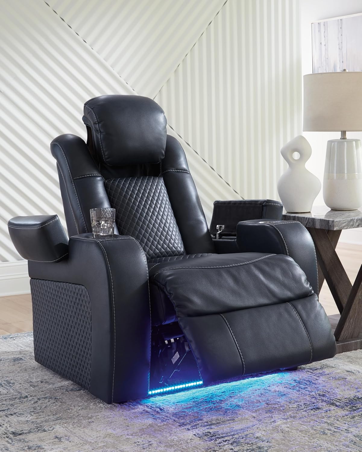 Close-up of the recliner's control panel with illuminated buttons, a cup holder, and a USB port.