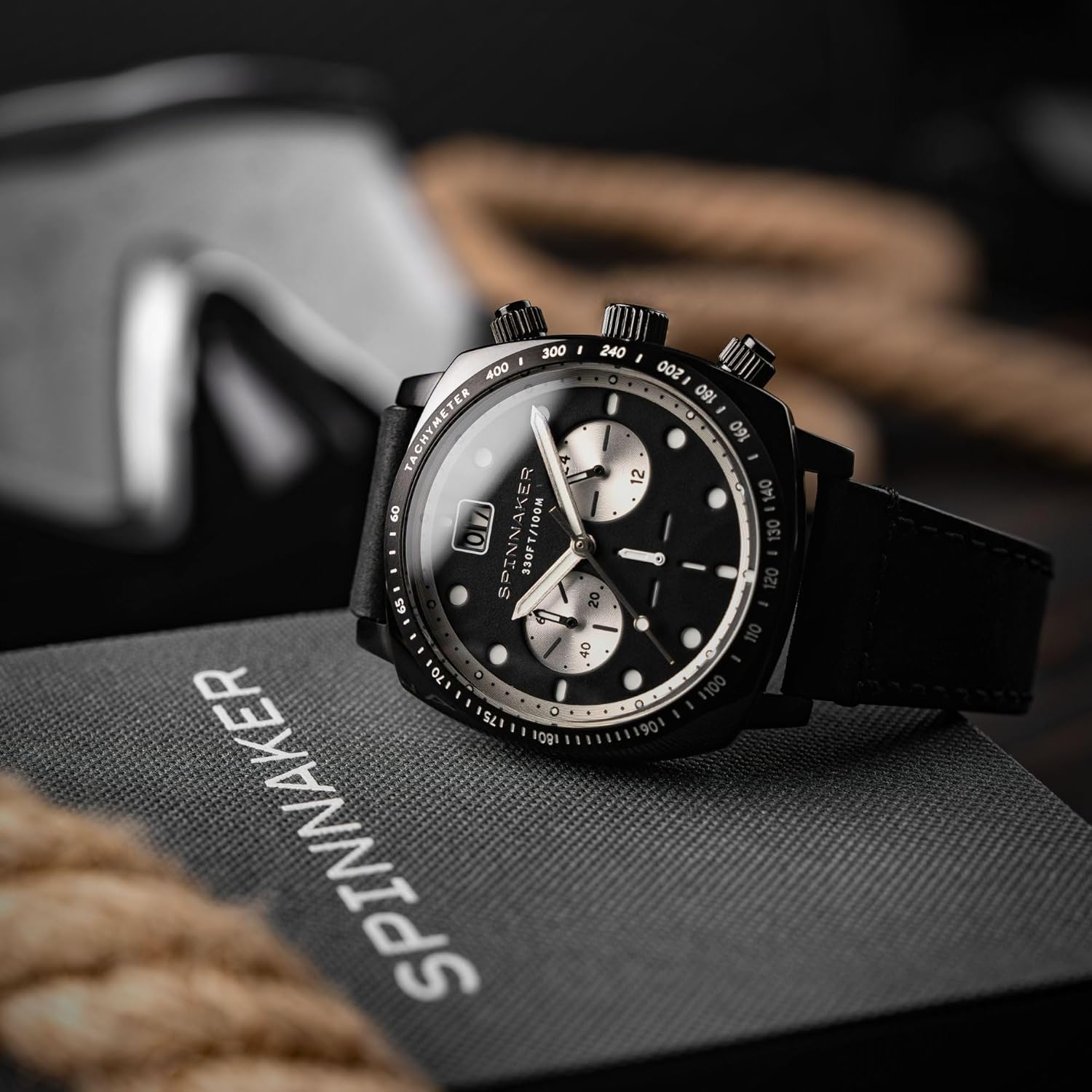 Spinnaker Hull Men's Chronograph Watch SP-5068 on its packaging box, showing the side profile with crown and pushers.