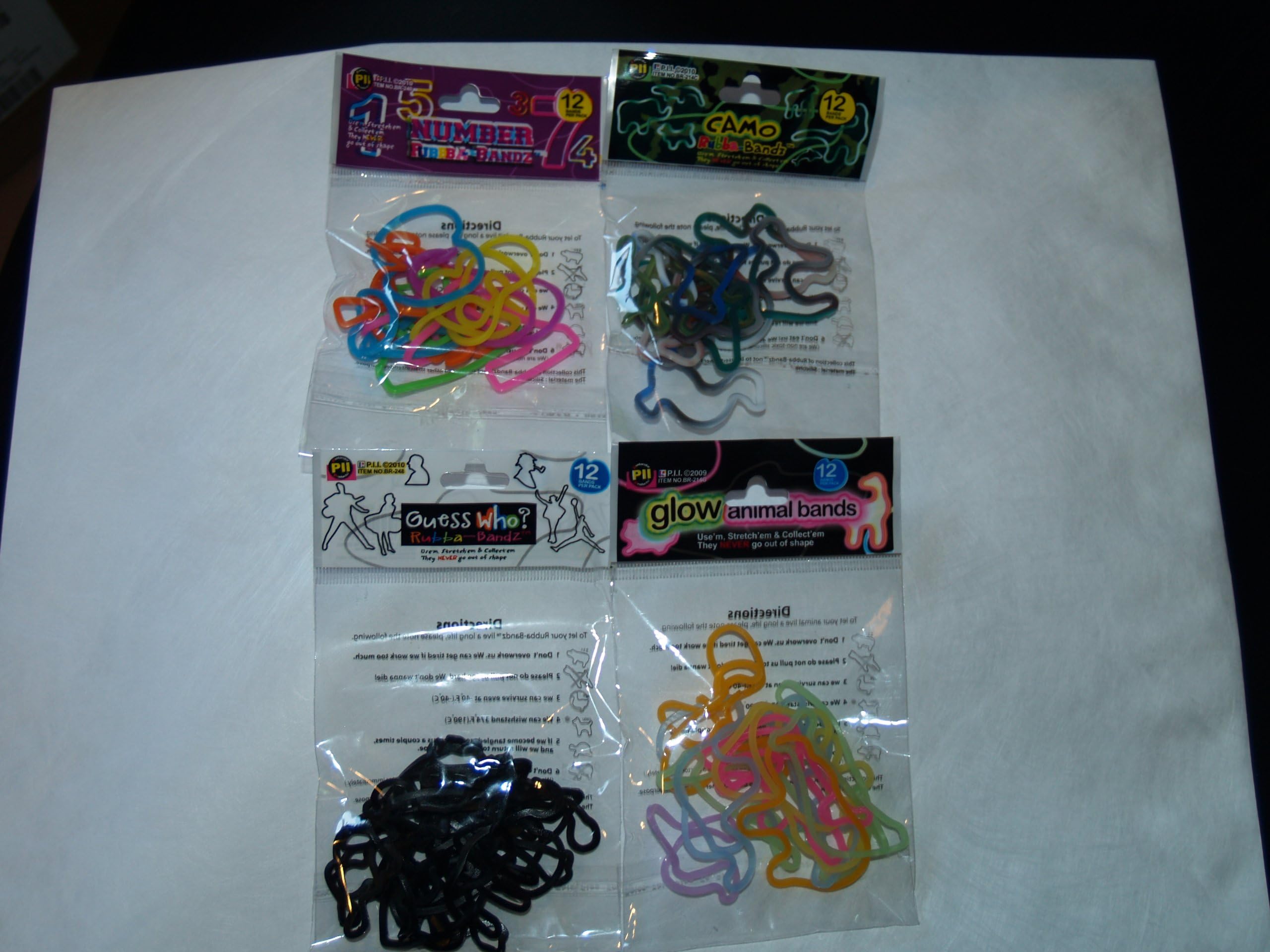 Rubber Bands 48 Piece Set Which Includes 4 (12 Piece) Packs ofCamouflageGuess Who?GLOW AnimalNumbers