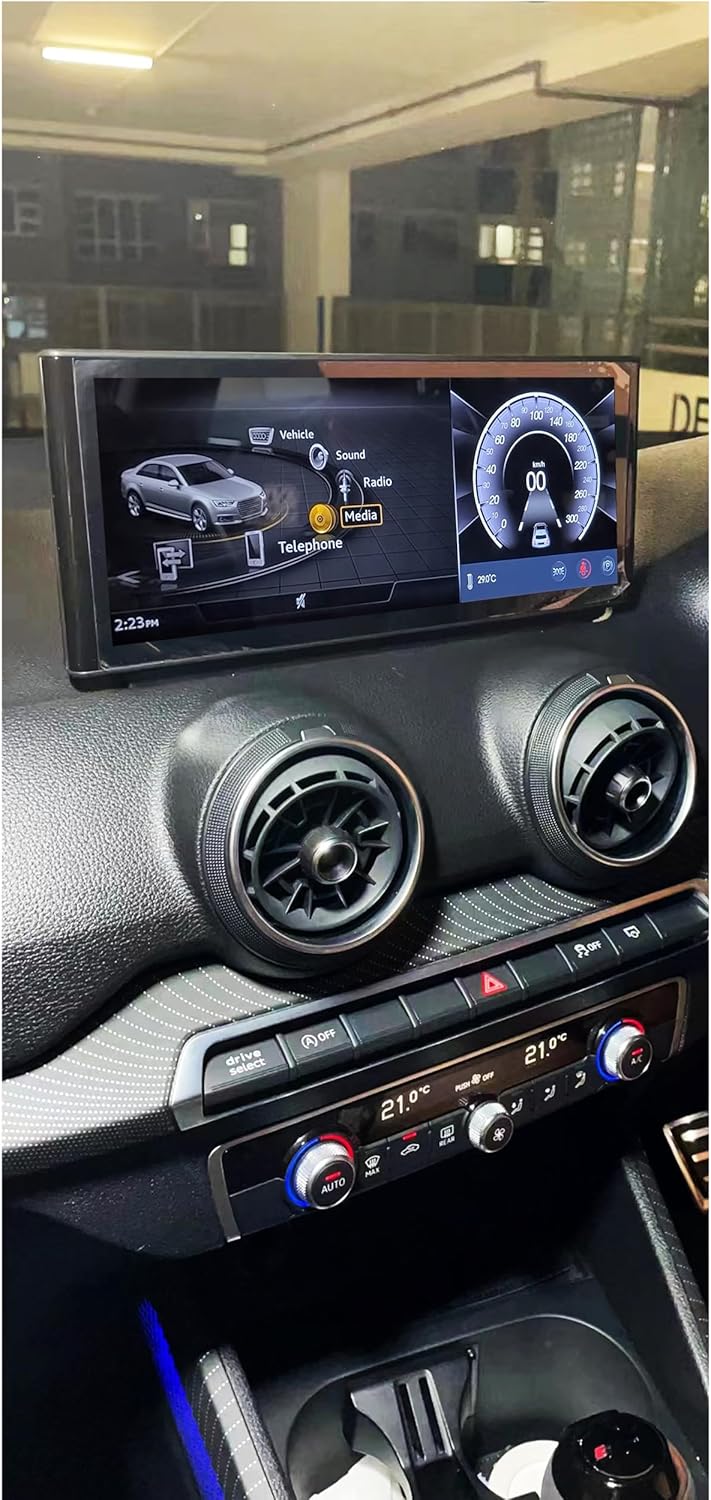 Car interior view showing the screen displaying the original Audi MMI interface with Vehicle, Sound, Radio, and Telephone options.