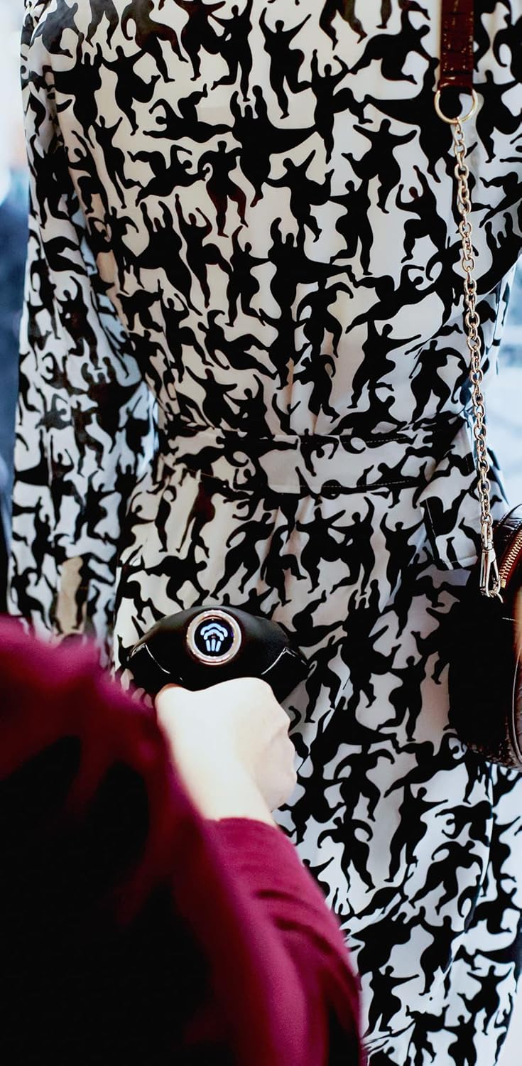 Person using SteamOne PRO300SB steamer on a patterned dress