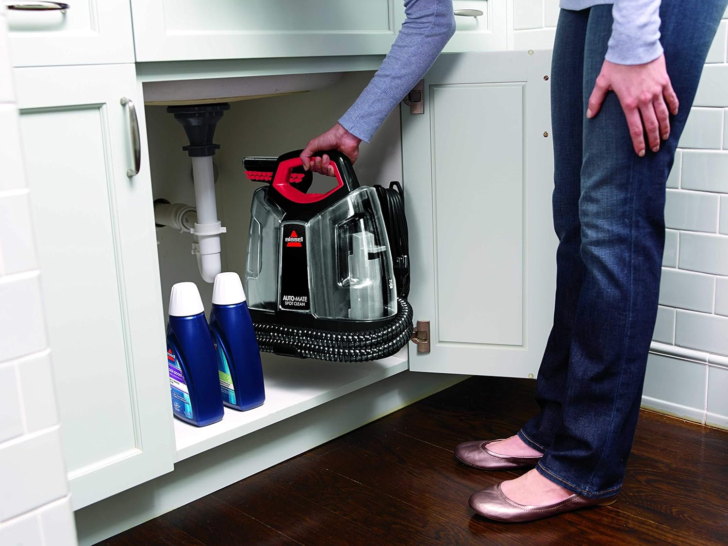 BISSELL MultiClean Spot & Stain unit with cleaning solutions, demonstrating compact storage.