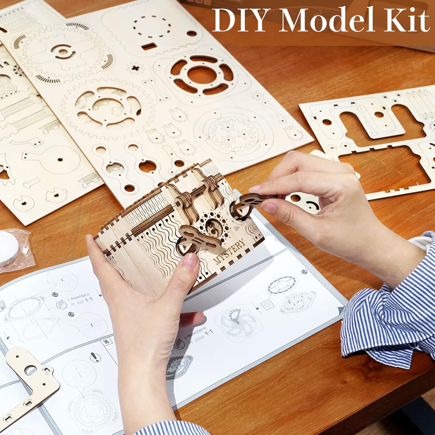 Hands assembling a wooden puzzle piece while following an instruction manual.