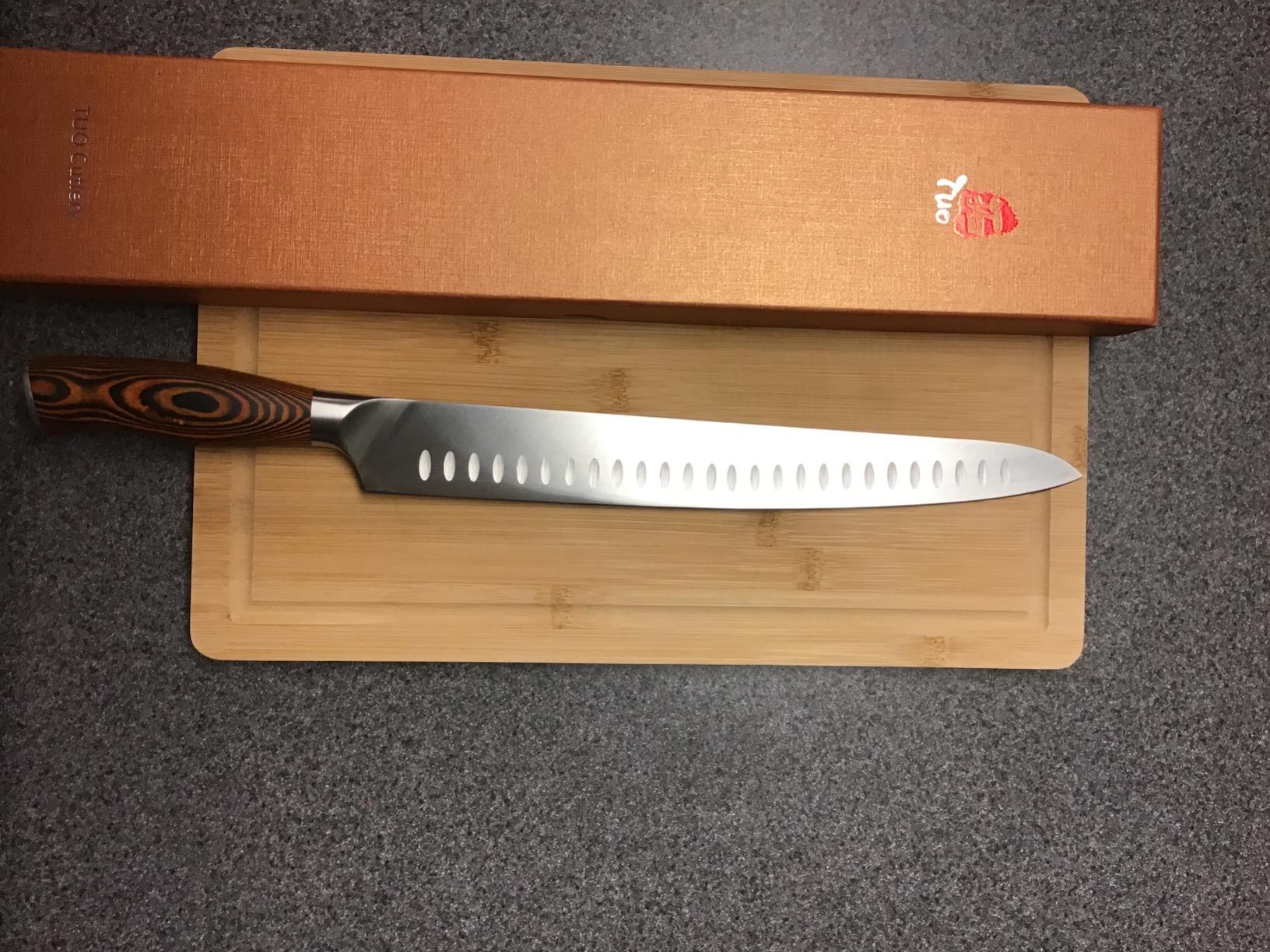 Close-up of TUO chef knife blade and handle detail