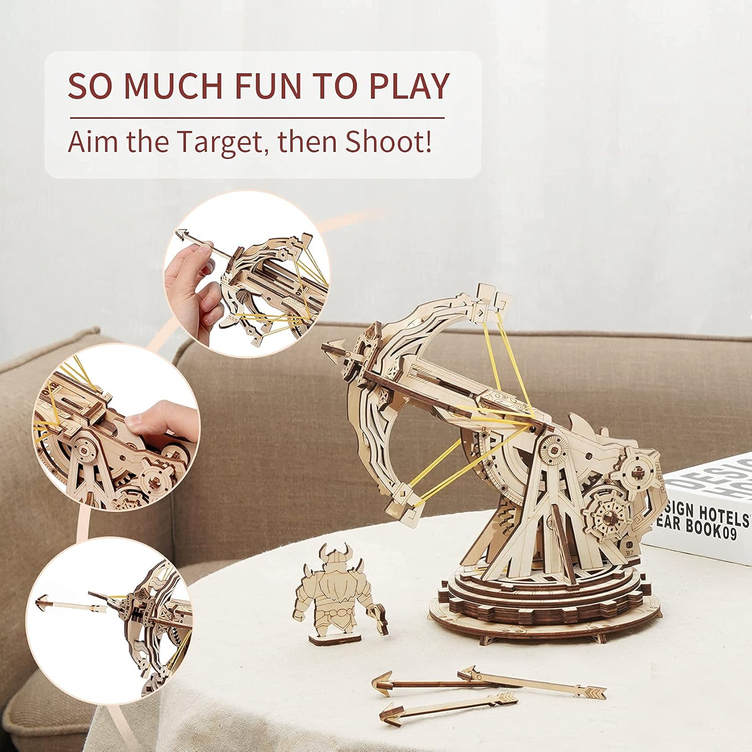 Hands assembling a wooden puzzle piece into the ballista base