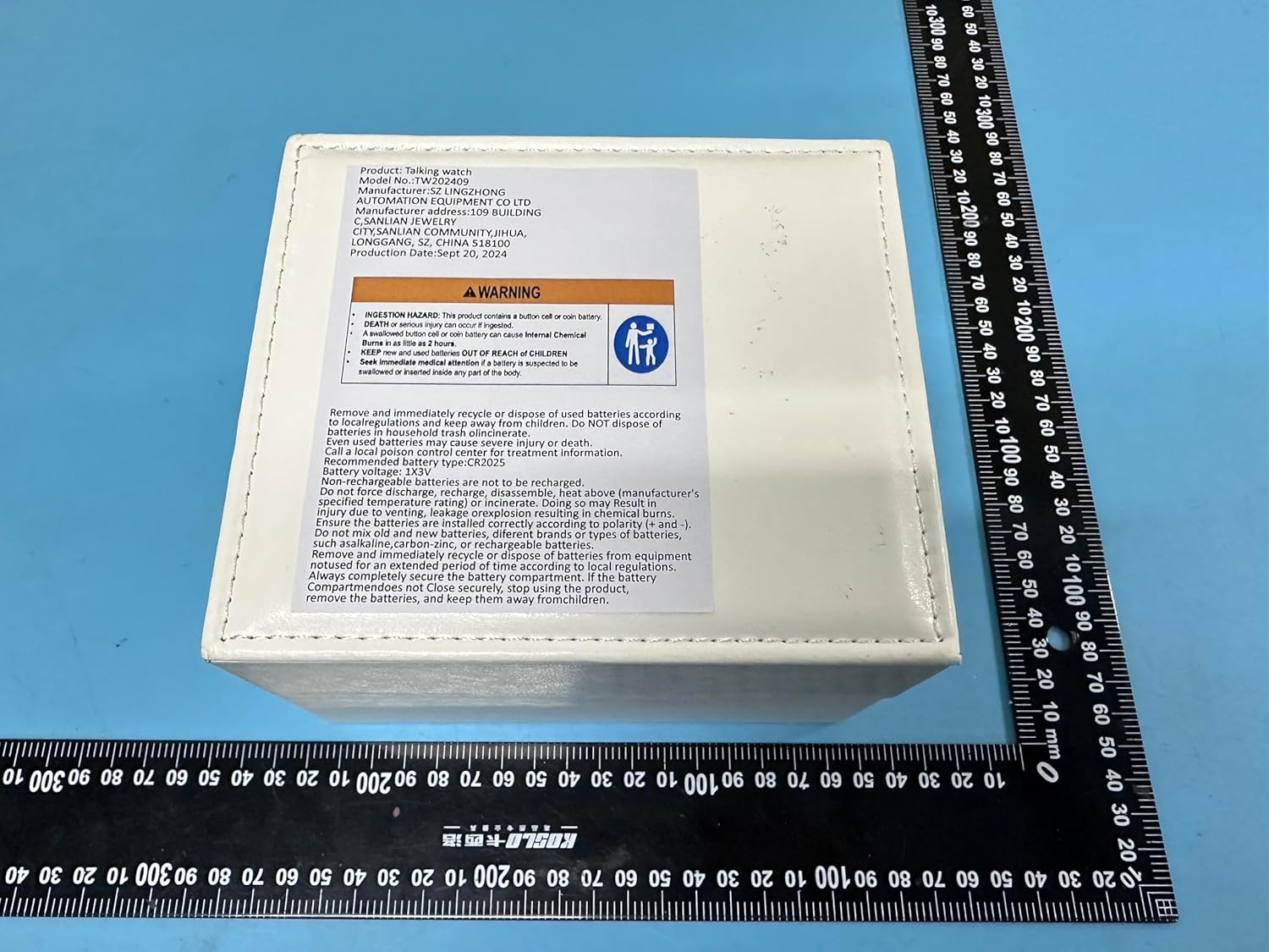 Back of the ViLoSa Talking Watch box with a warning label about button cell batteries.