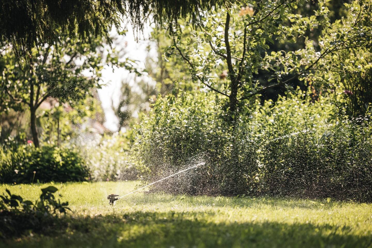 Fiskars Irrigatore a Impulso XL di Metallo con Ruote, Con Distanza | Getto e Rotazione Regolabili, Misura Universale, Portata Ø 26 m, 938 g, Nero/Arancione, 1023656