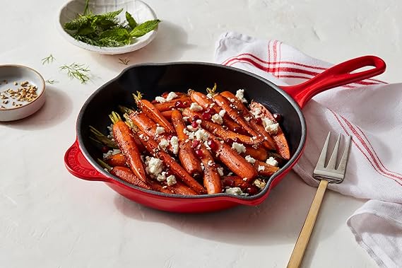 The skillet has an attractive Cerise color, which adds a touch of elegance to any kitchen. It features a handle made of cast iron, providing a secure and comfortable grip while cooking. The handle is also designed to stay cool during stovetop use, ensuring safe handling when hot.