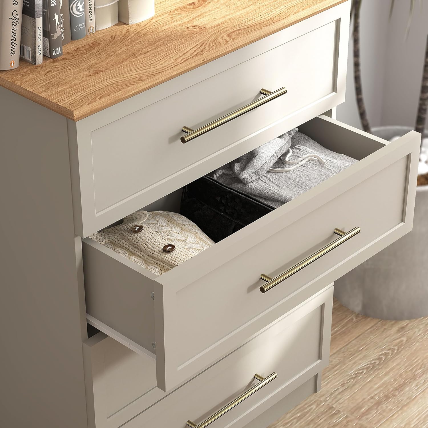 Open drawer of the Galano Cleverton chest showing stored clothes.