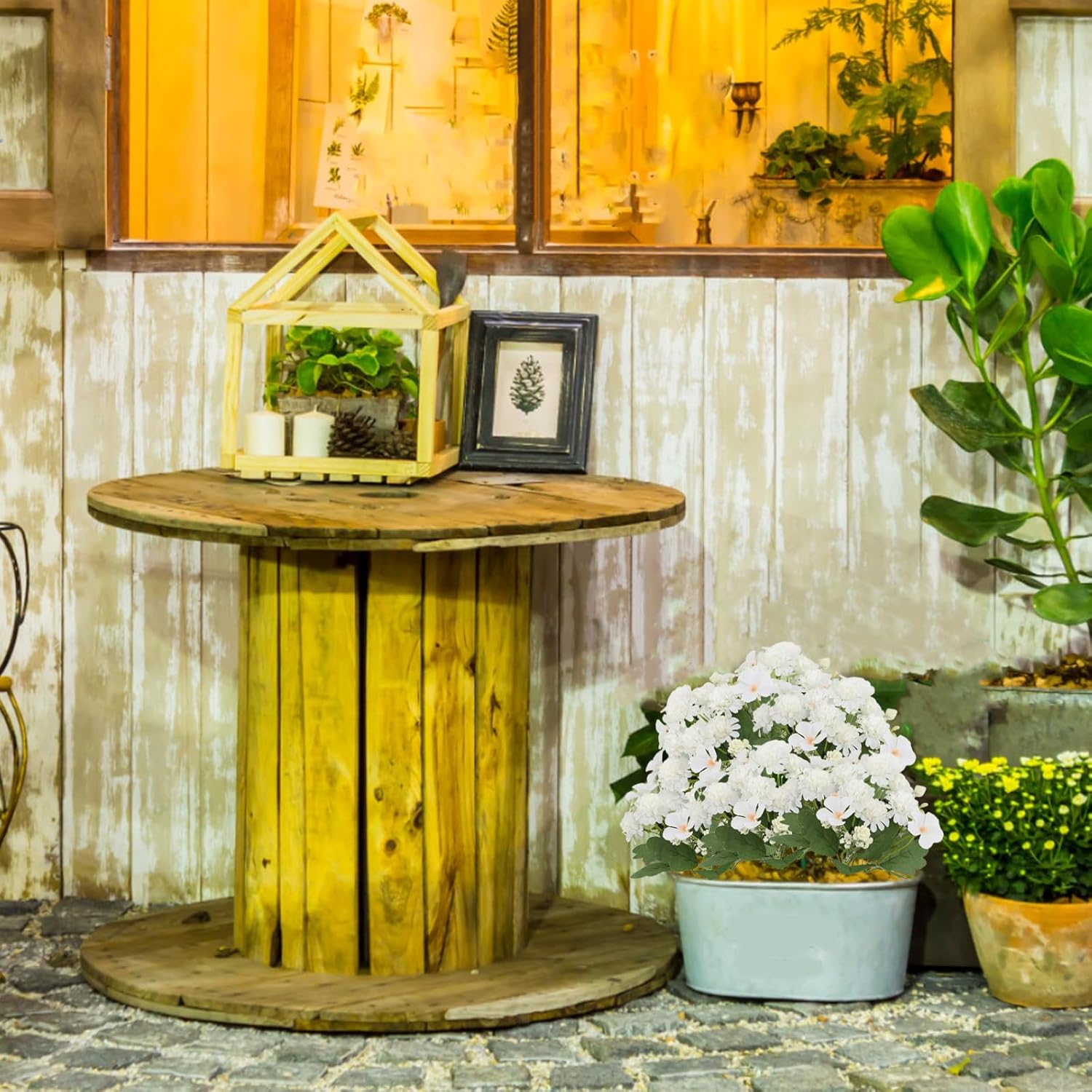 Artificial chrysanthemum flowers in a pot in an outdoor garden setting
