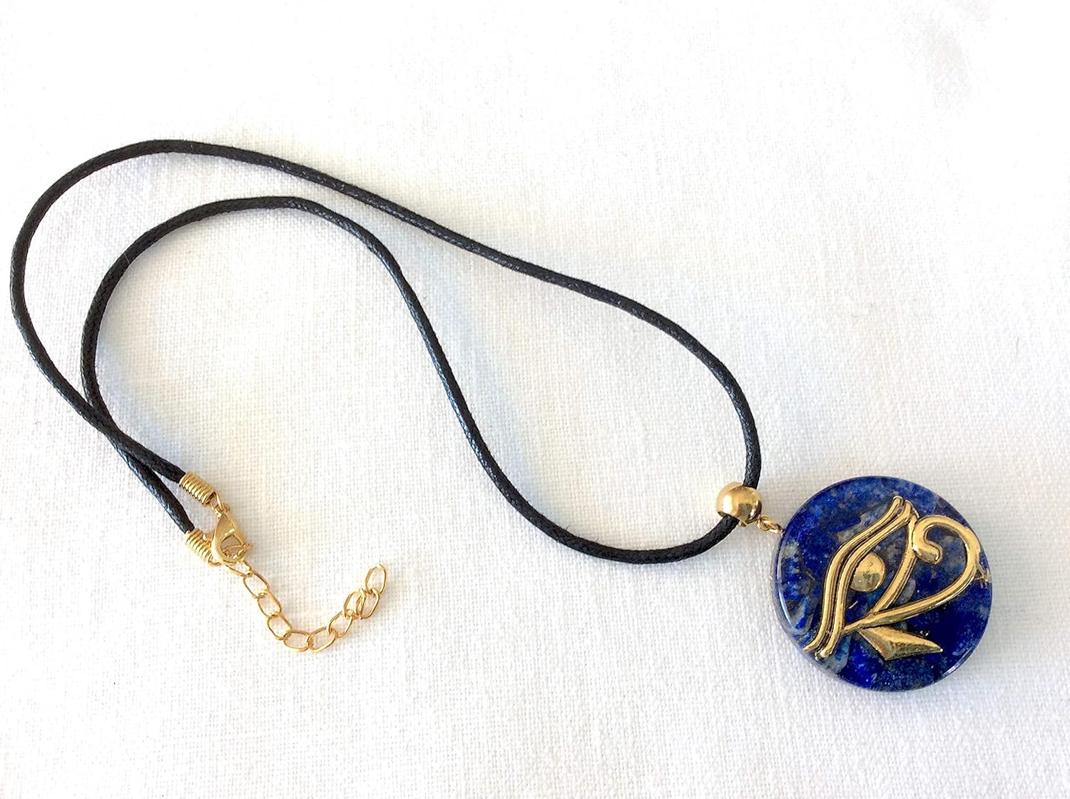 Orgone pendant necklace with golden Eye of Horus and Lapis Lazuli stones. Egyptian amulet 1.38 inch diameter. Made in USA