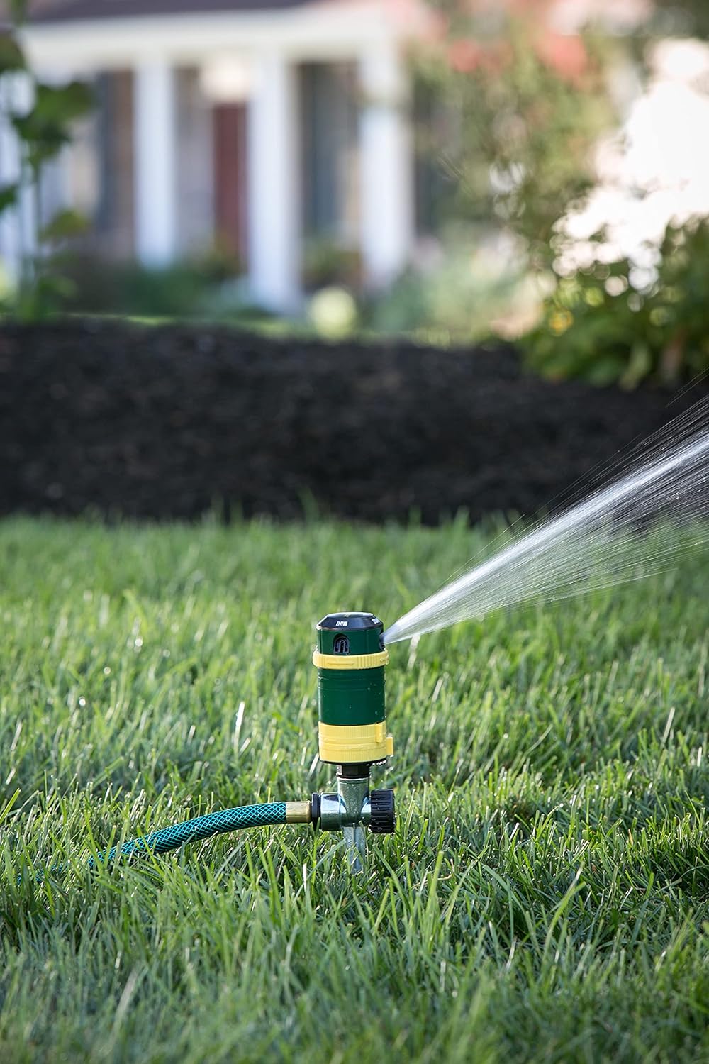 Melnor Turbo Rotary Sprinkler in action, demonstrating water distribution over a lawn.