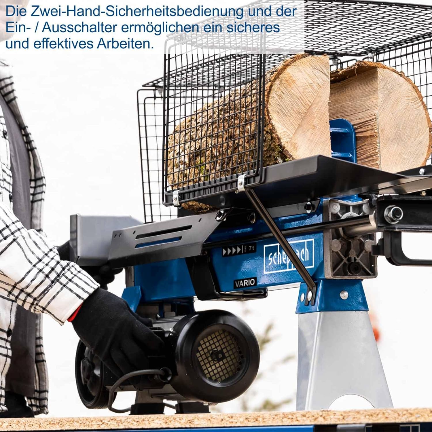 User operating the log splitter with both hands on the safety controls