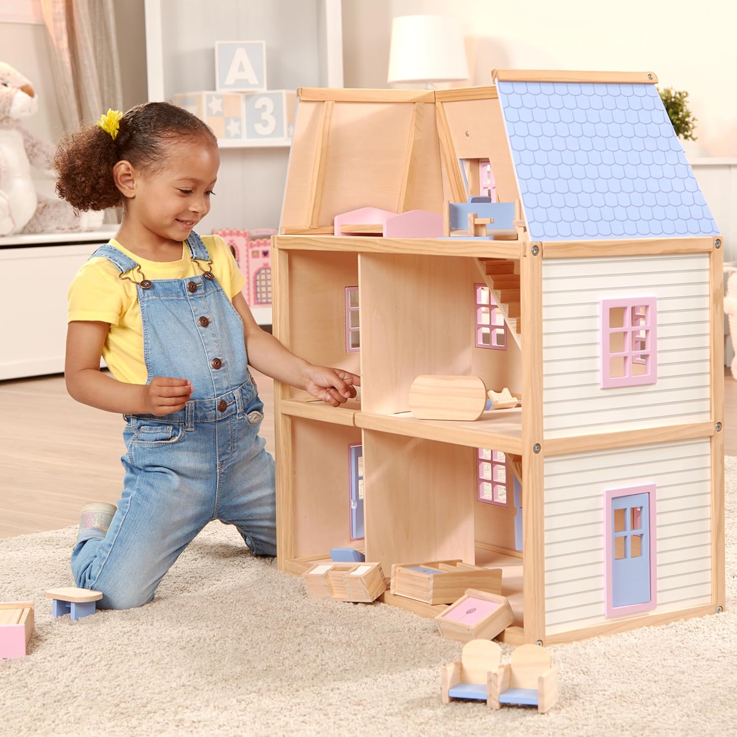 A collection of 30 pieces of Melissa & Doug wooden dollhouse furniture.