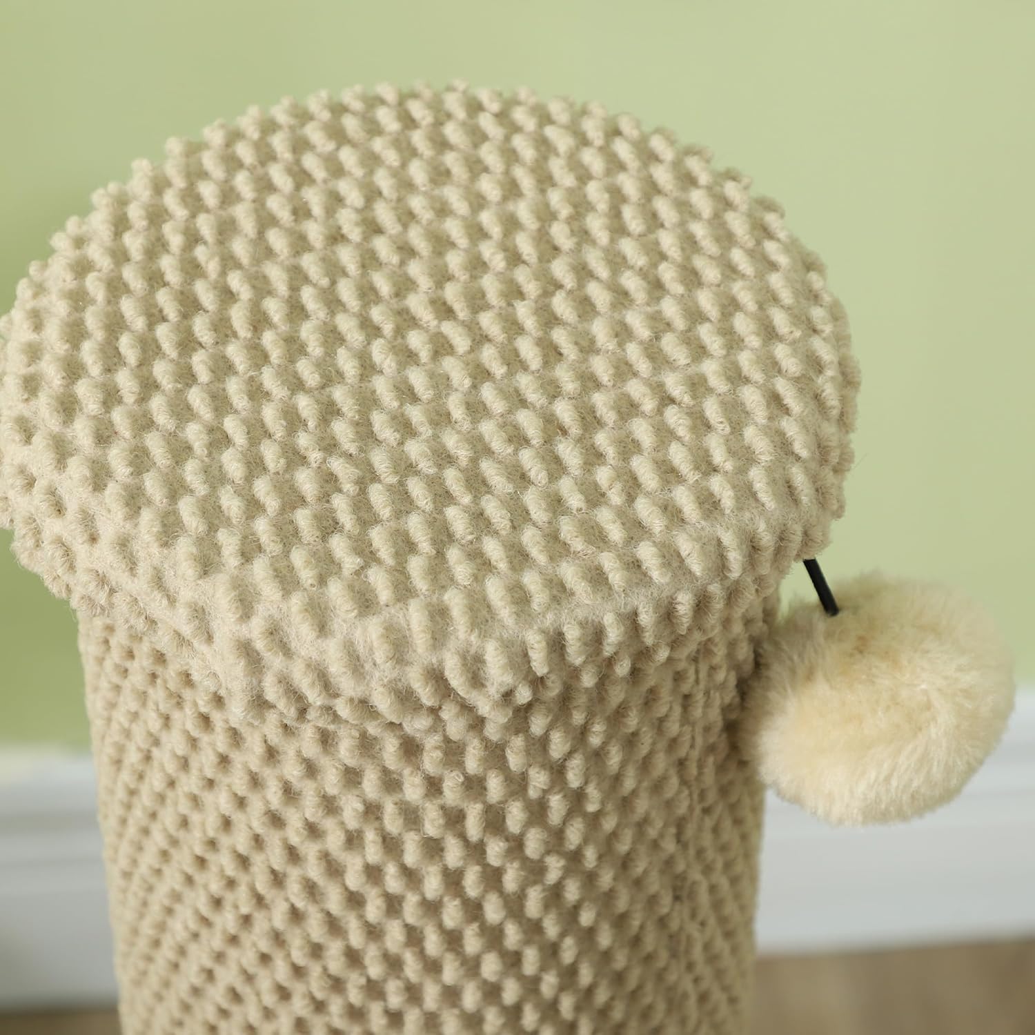 Close-up of the top of the scratching post, showing the attached toy ball.