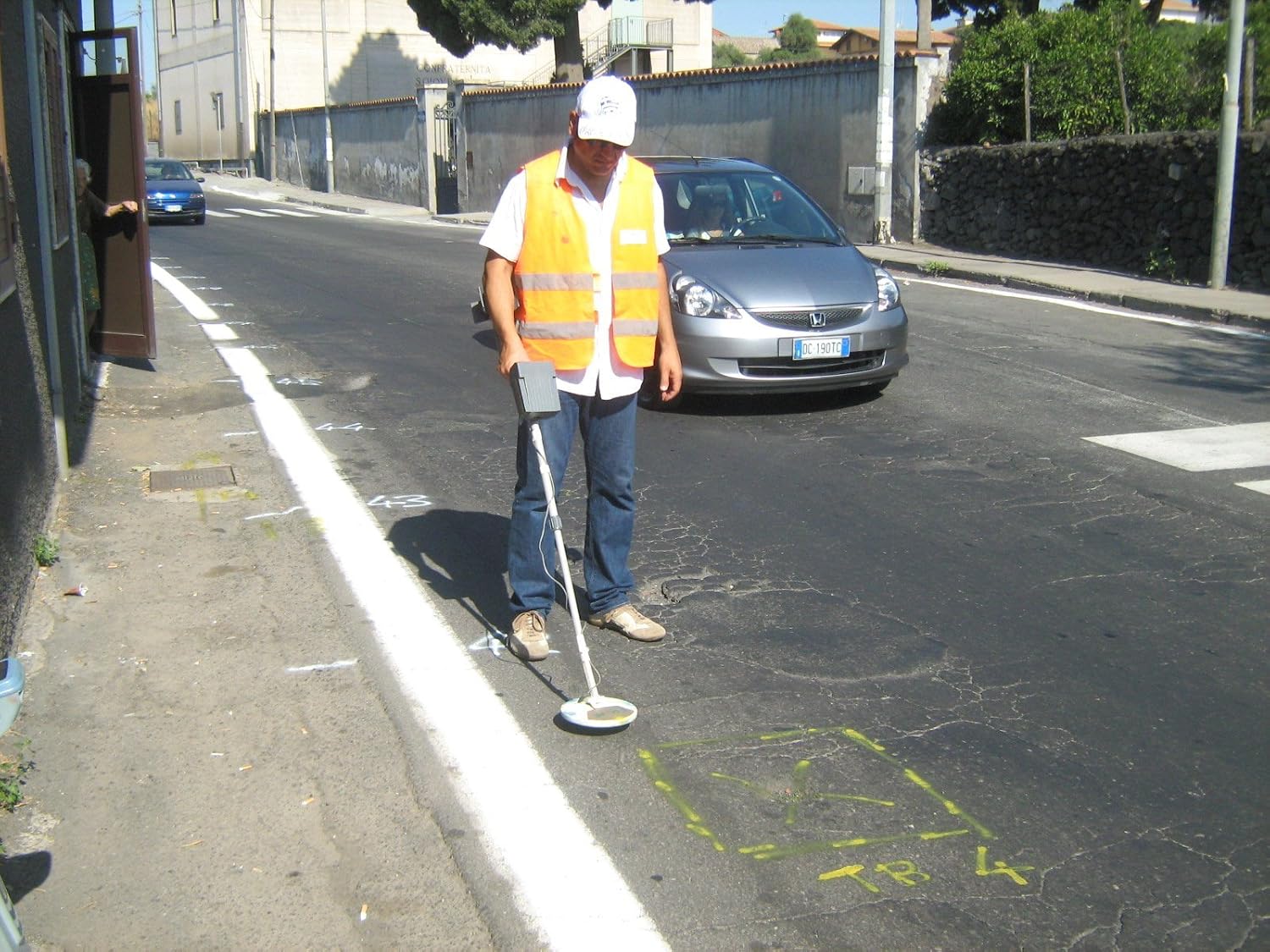 Operator using C.Scope CS880 metal detector on a road