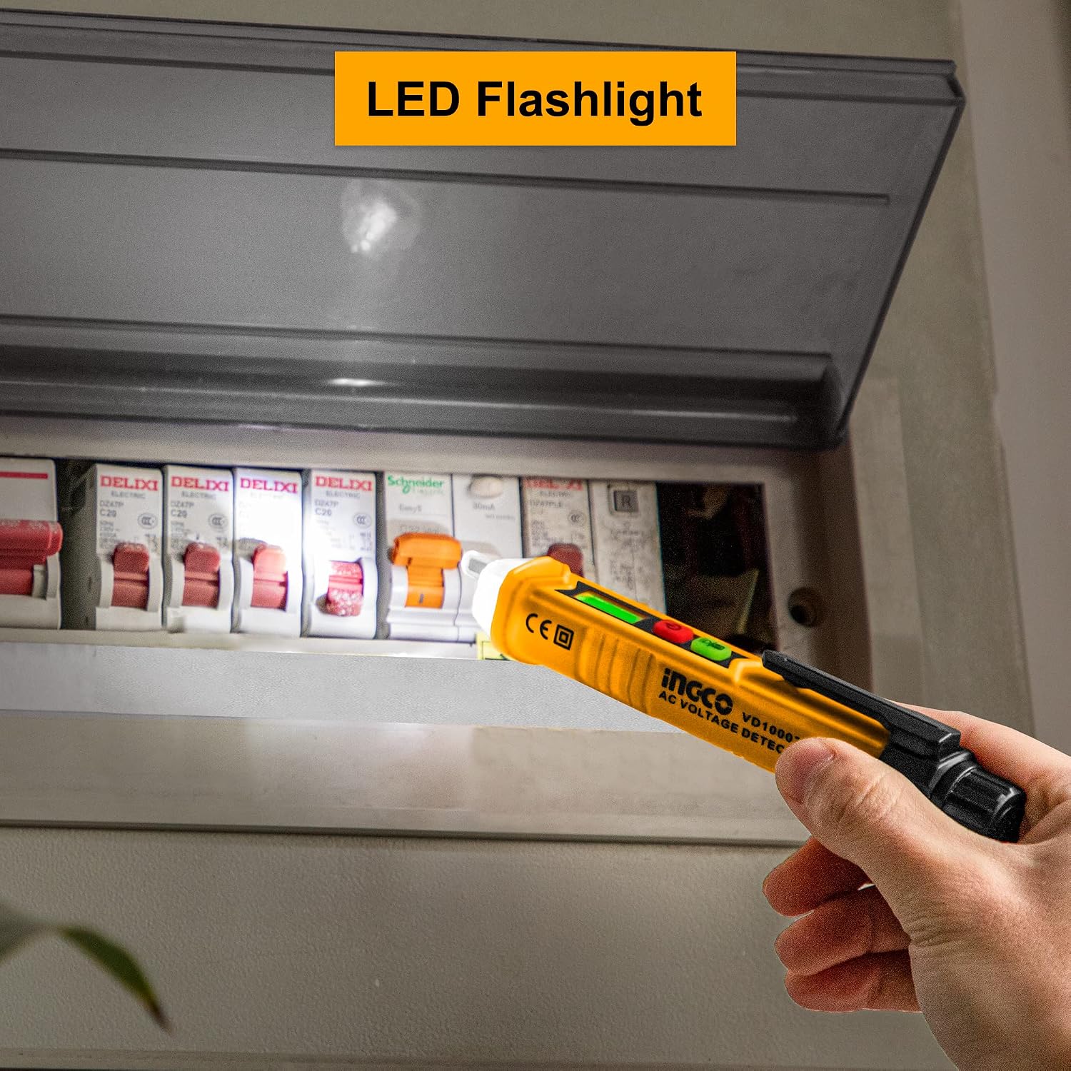 Hand using INGCO AC Voltage Detector's LED flashlight to illuminate a circuit breaker box