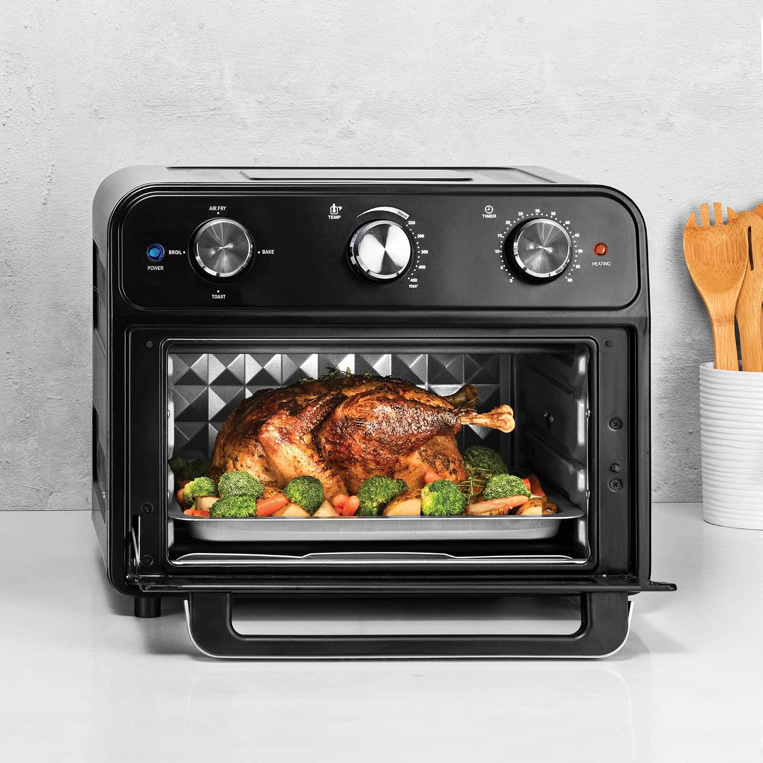 Close-up of the Kalorik AFO 46129 BK Air Fryer Toaster Oven control panel with three silver knobs and indicator lights.