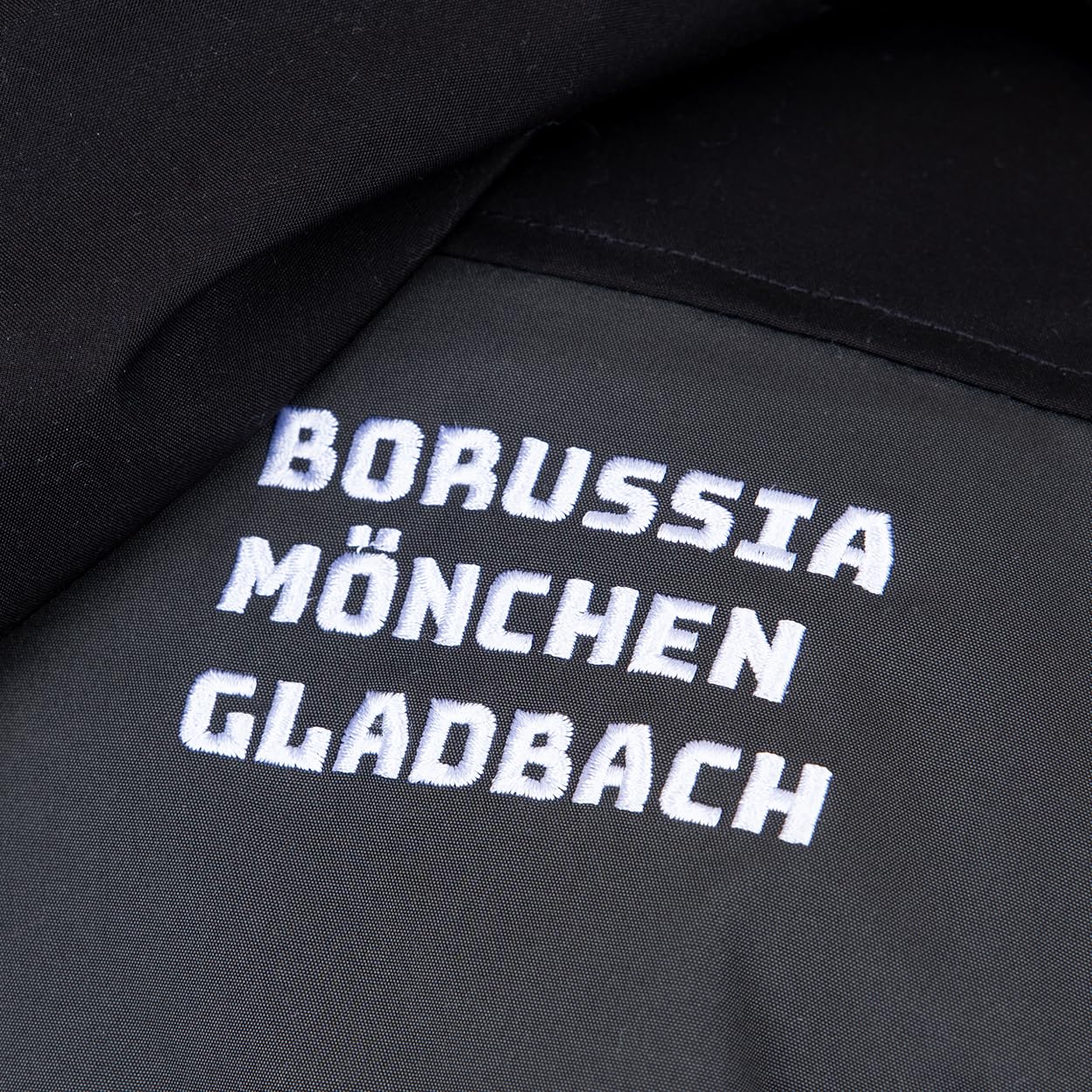 Borussia Mönchengladbach Übergangsjacke „Spring“ | Offizieller Fanartikel Fohlenshop | Gladbach Jacke Dunkelgrau Kapuze Abnehmbar