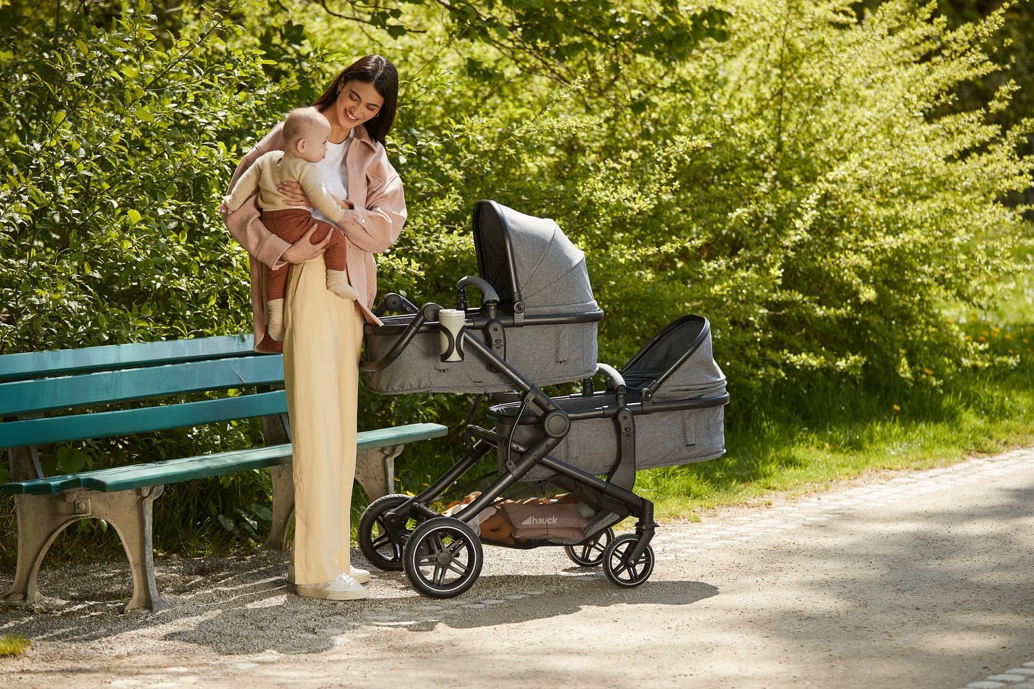Parent with Hauck Atlantic Twin double stroller in carrycot mode