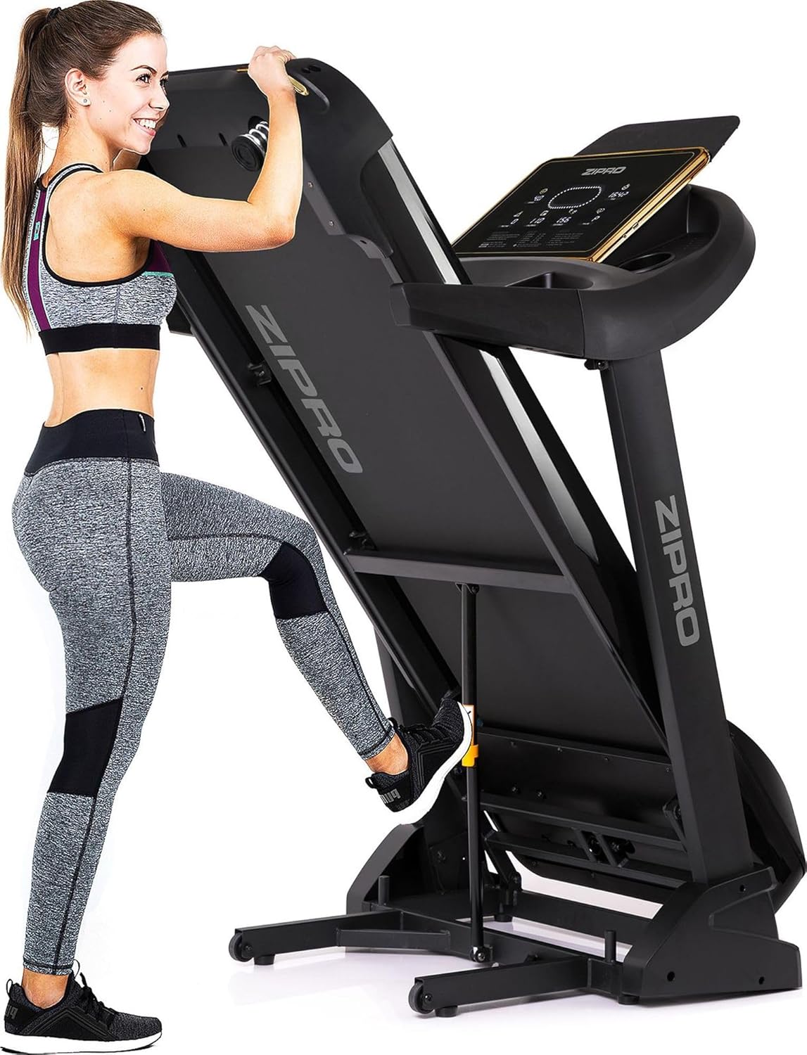 Woman demonstrating the folding mechanism of the ZIPRO Pacemaker Gold Treadmill.