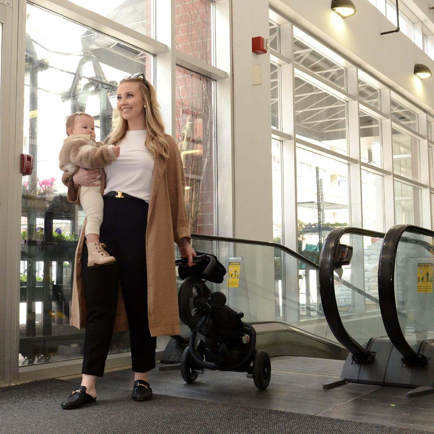 Parent carrying the folded QPlay Rito tricycle