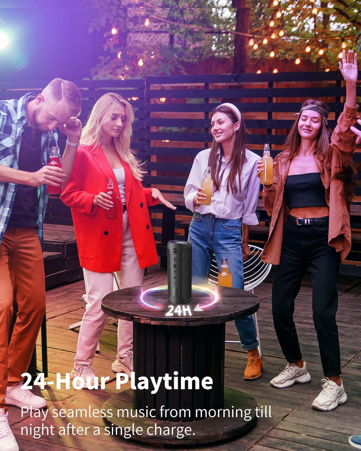 AUKTECH AK01 Pro speaker on a wooden table with people dancing in the background, illustrating 24-hour playtime.