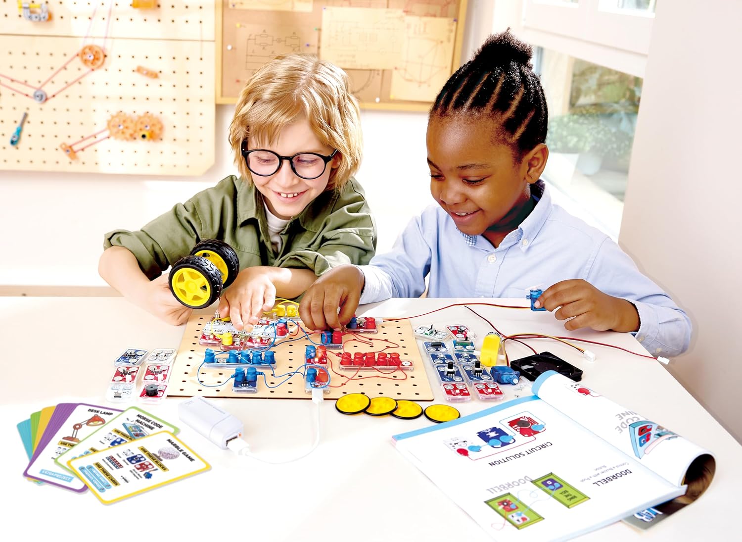 Two children collaborating on a Hape Circuit Explorer Lab Kit project