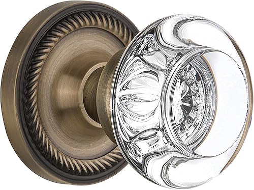 Nostalgic Warehouse 712228, Pasaje de 2.375 pulgadas, roseta de cuerda de latón antiguo con perilla redonda de cristal transparente