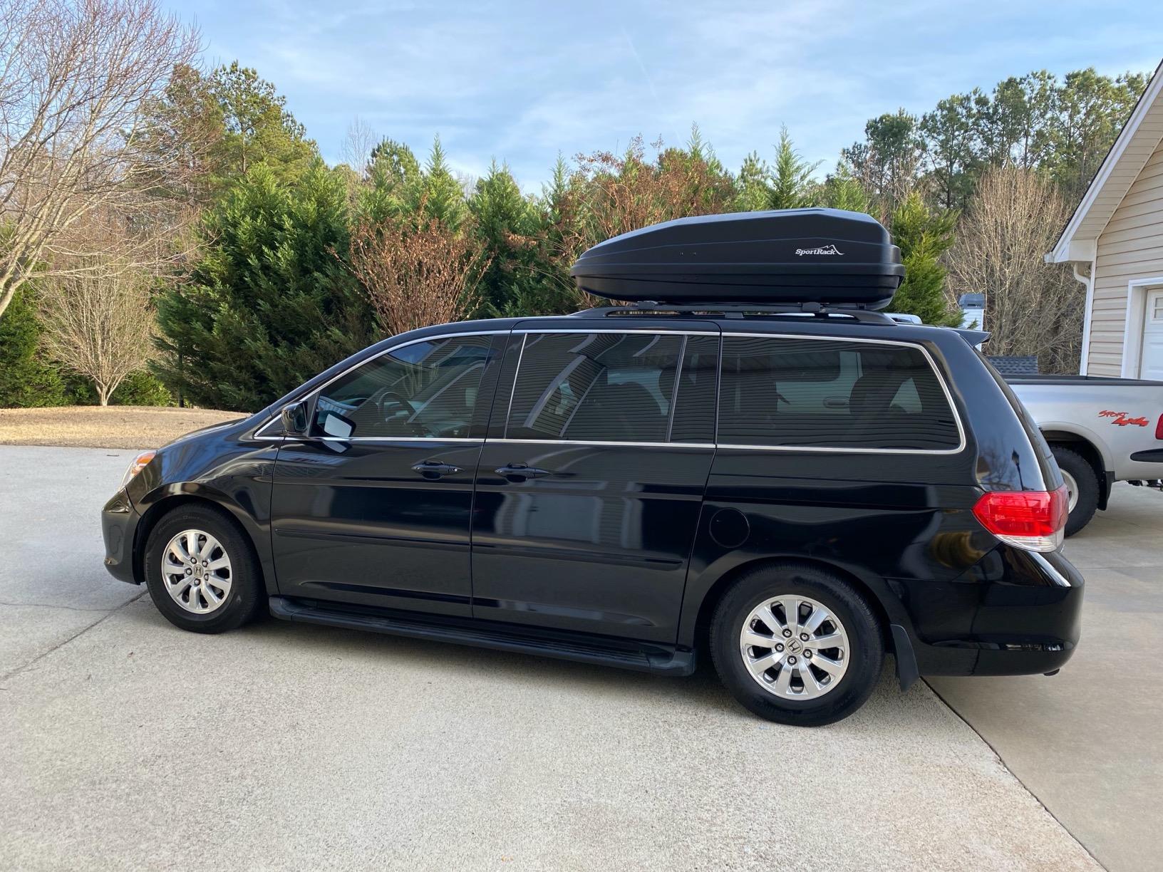 Yakima SkyBox NX 18 open showing full interior with camping gear and luggage packed inside