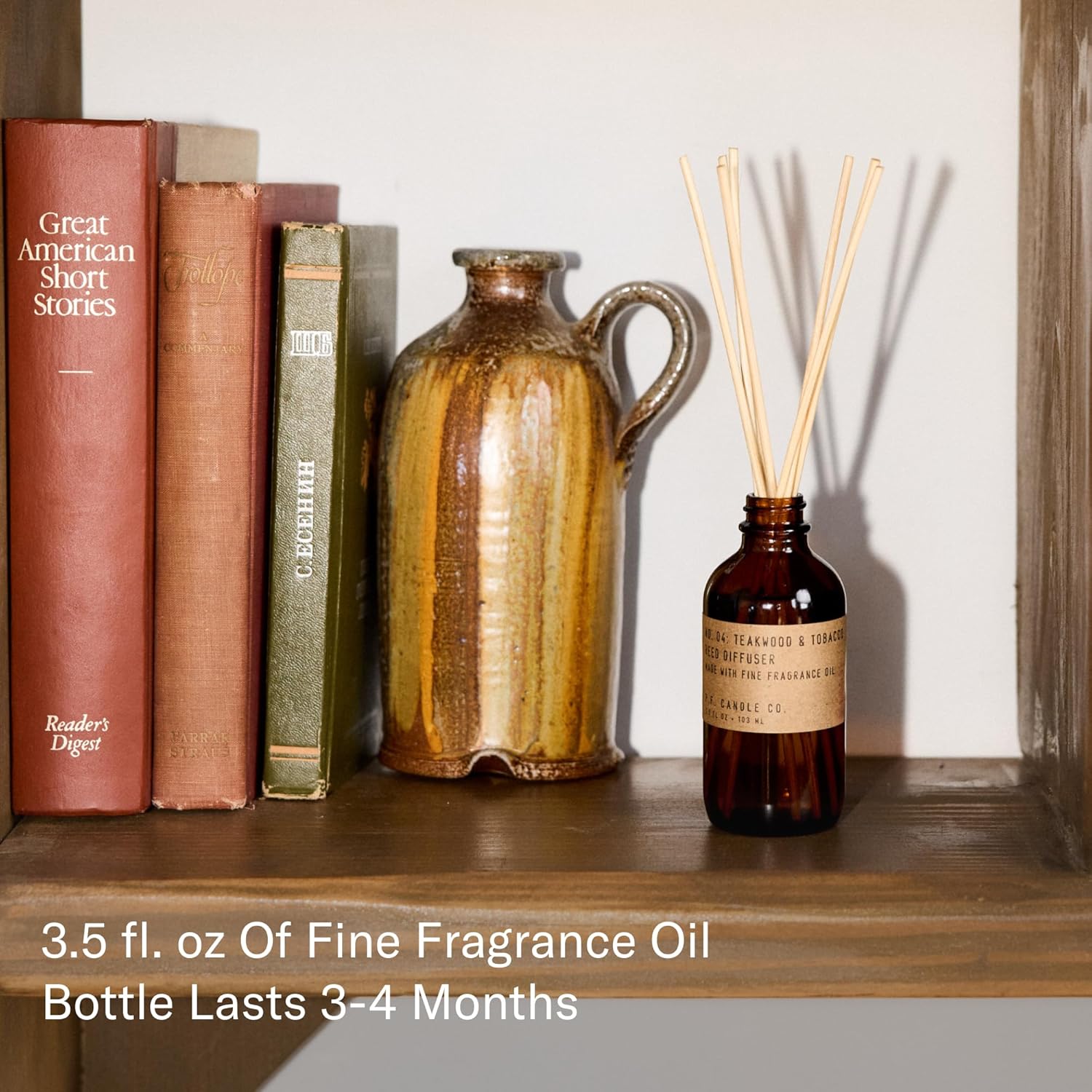 P.F. Candle Co. Teakwood & Tobacco Classic Scented Rattan Reed Diffuser (3.5 fl oz) Amber Glass Jar, Fine Fragrance Oil, Low Maintenance Scent Throw, Made in The U.S.A.