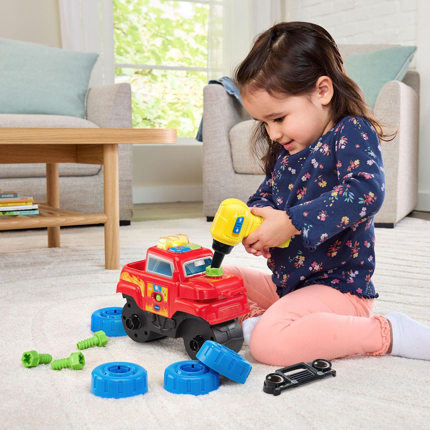 Child using toy drill to assemble VTech Monster Truck