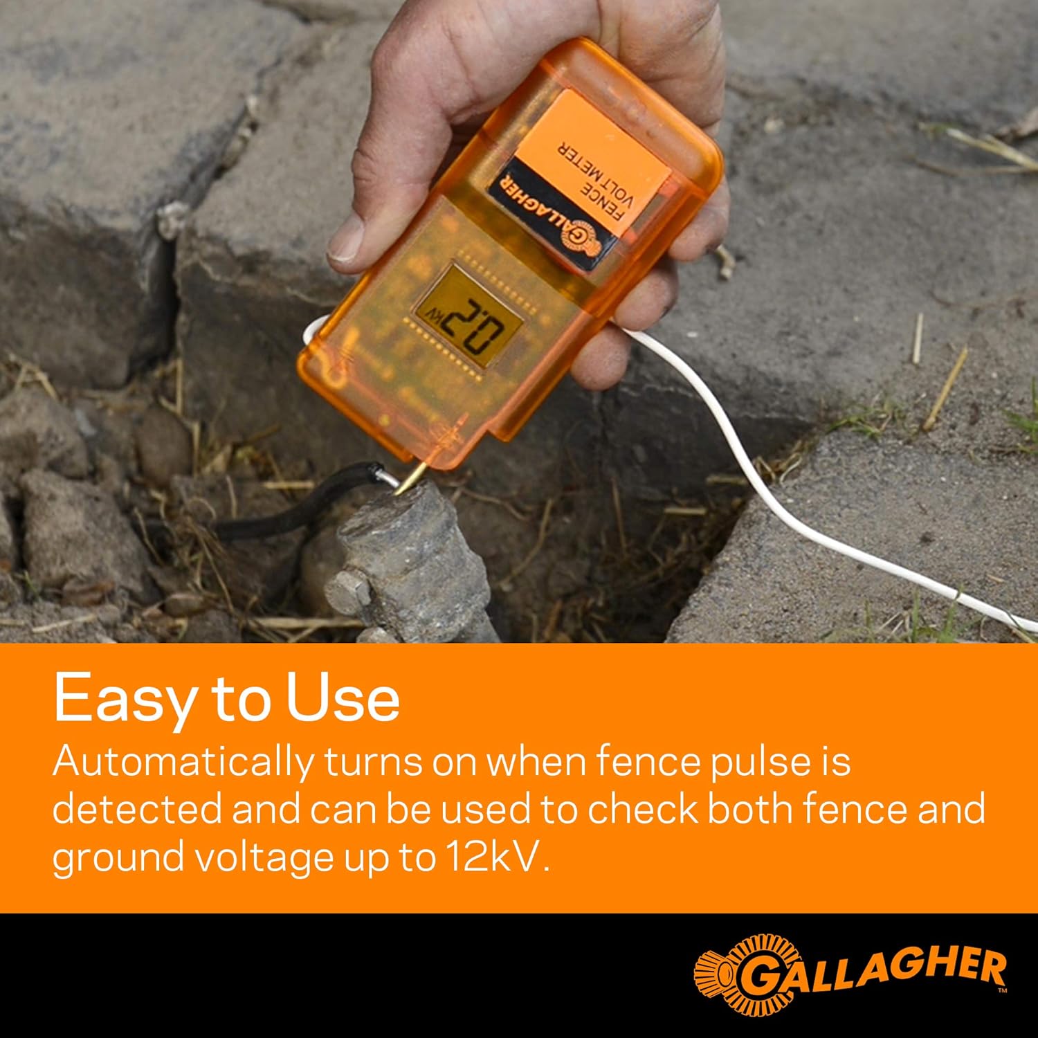 Hand holding Gallagher Digital Volt Meter, touching fence and ground