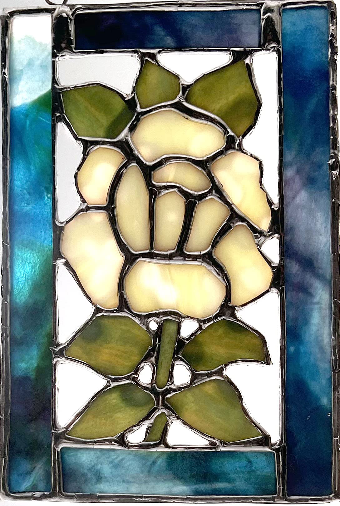 Handmade stained glass yellow Rose with Green Leaves and Stem set into Blue and Green Glass Frame