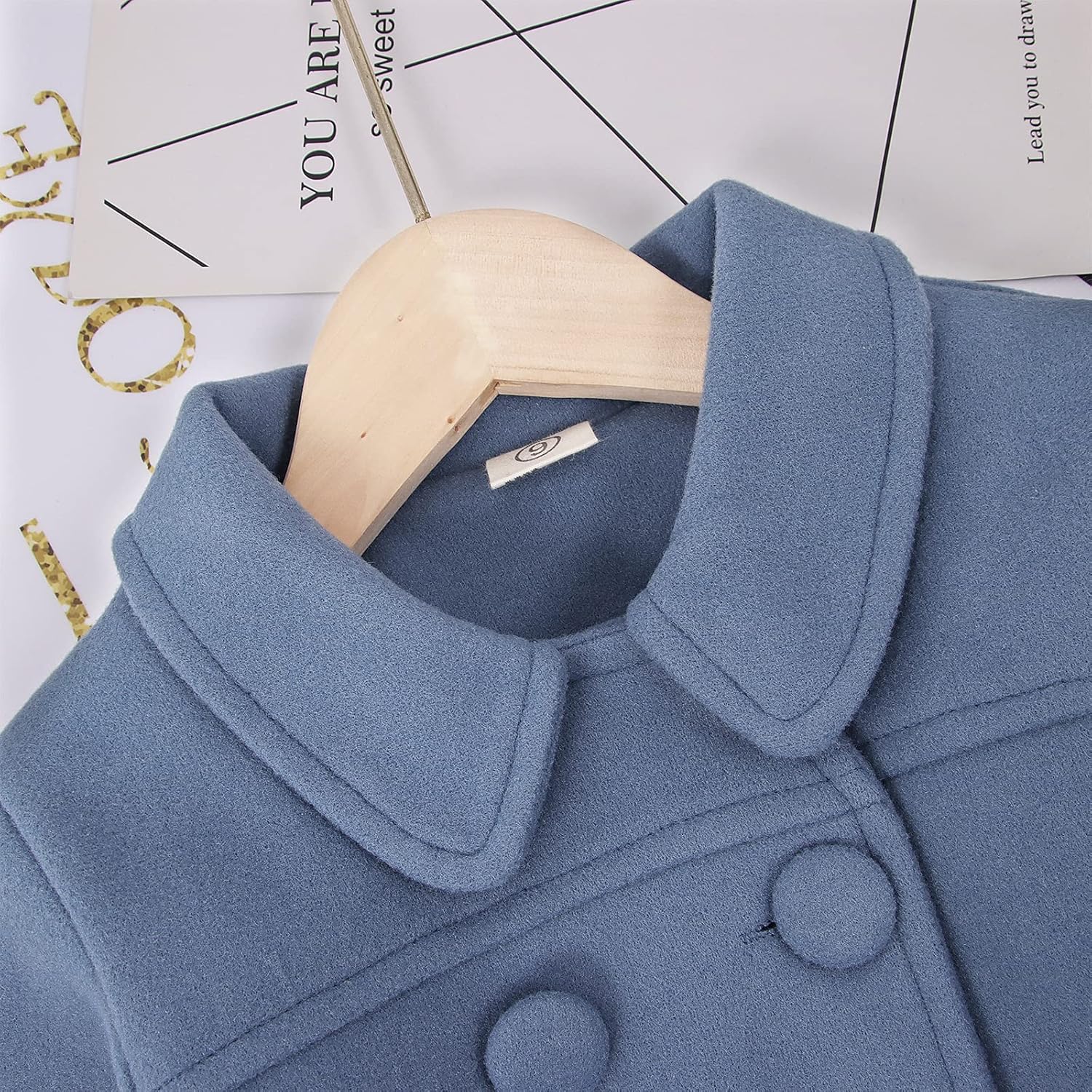 Close-up of a blue winter coat's collar and buttons.