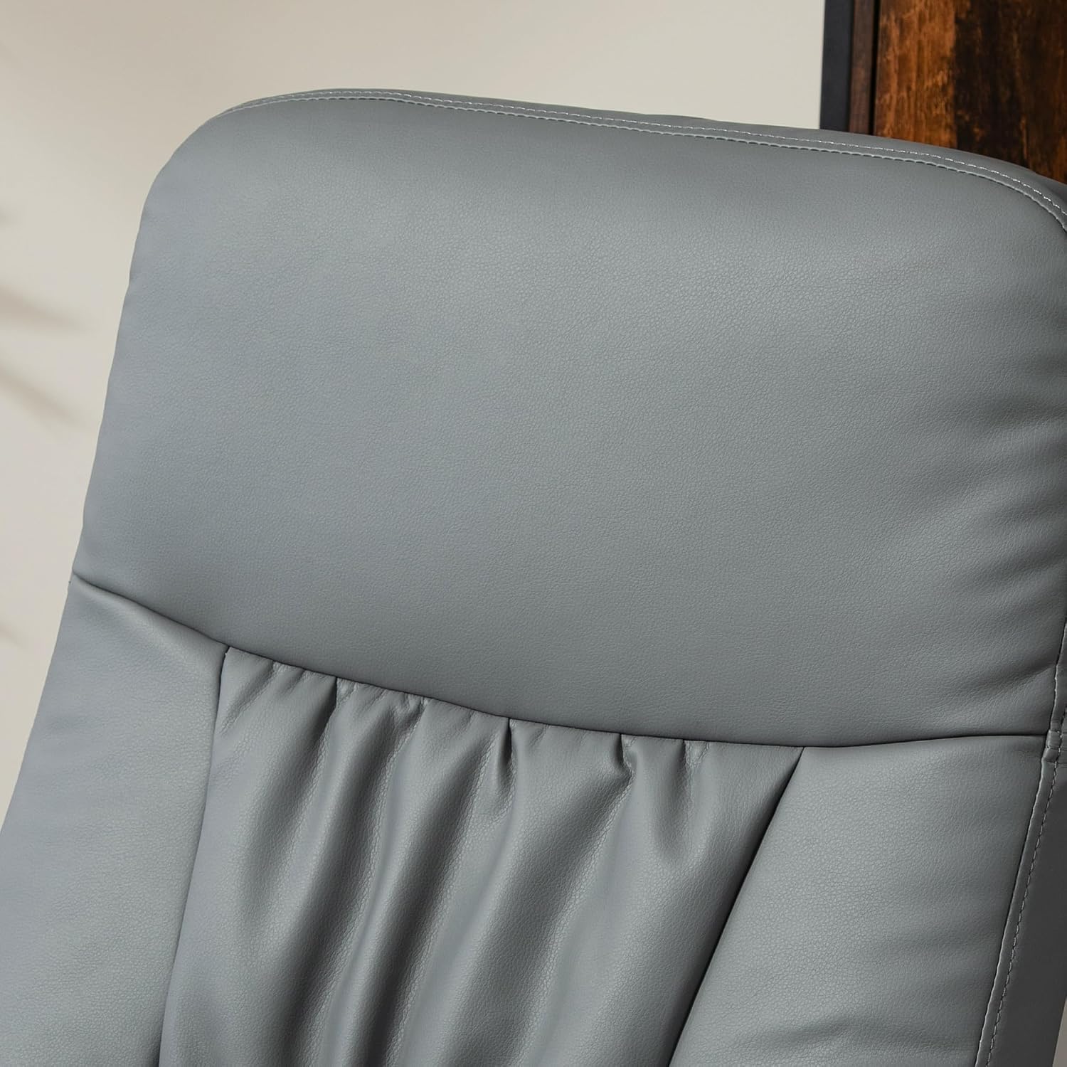 Diagram highlighting high comfort features: PU Leather Surface, Thick Padding, Solid Metal Base, and Ottoman for Relaxing Legs