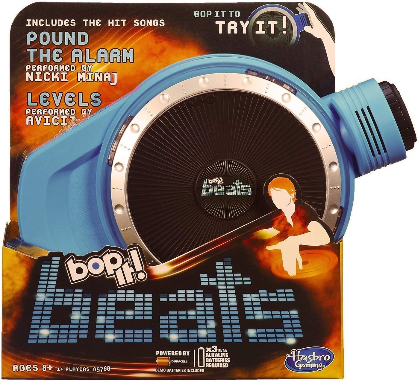 Hasbro Bop It Beats game in its packaging, showing the blue device with a central turntable and various controls. The packaging highlights 'Pound the Alarm' and 'Levels' as included songs.