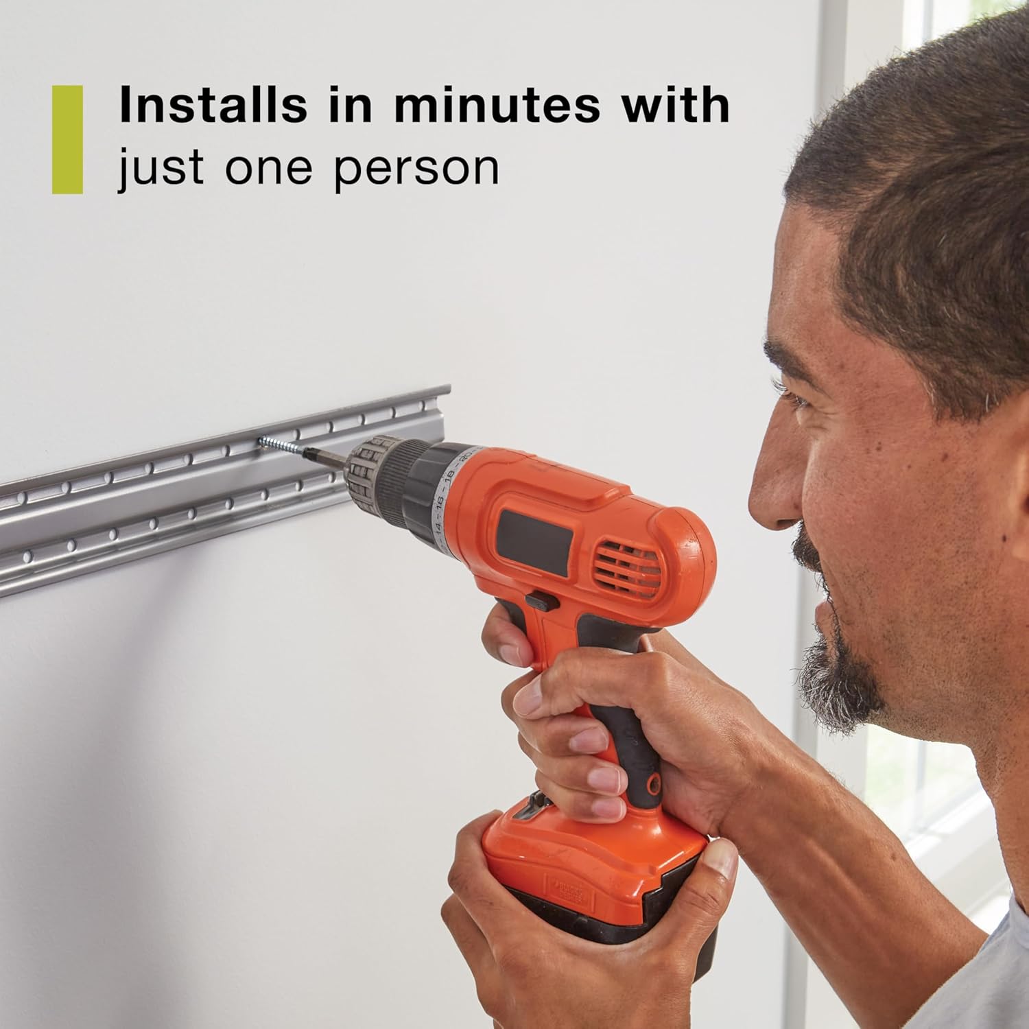 Image showing a person installing a Rubbermaid FastTrack rail onto a wall using a drill, with text 'Installs in minutes with just one person'.