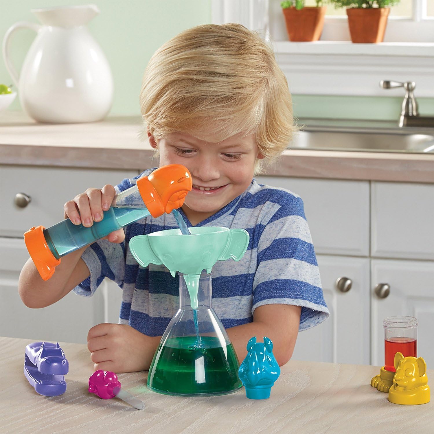 Child pouring liquid into a flask with the elephant funnel